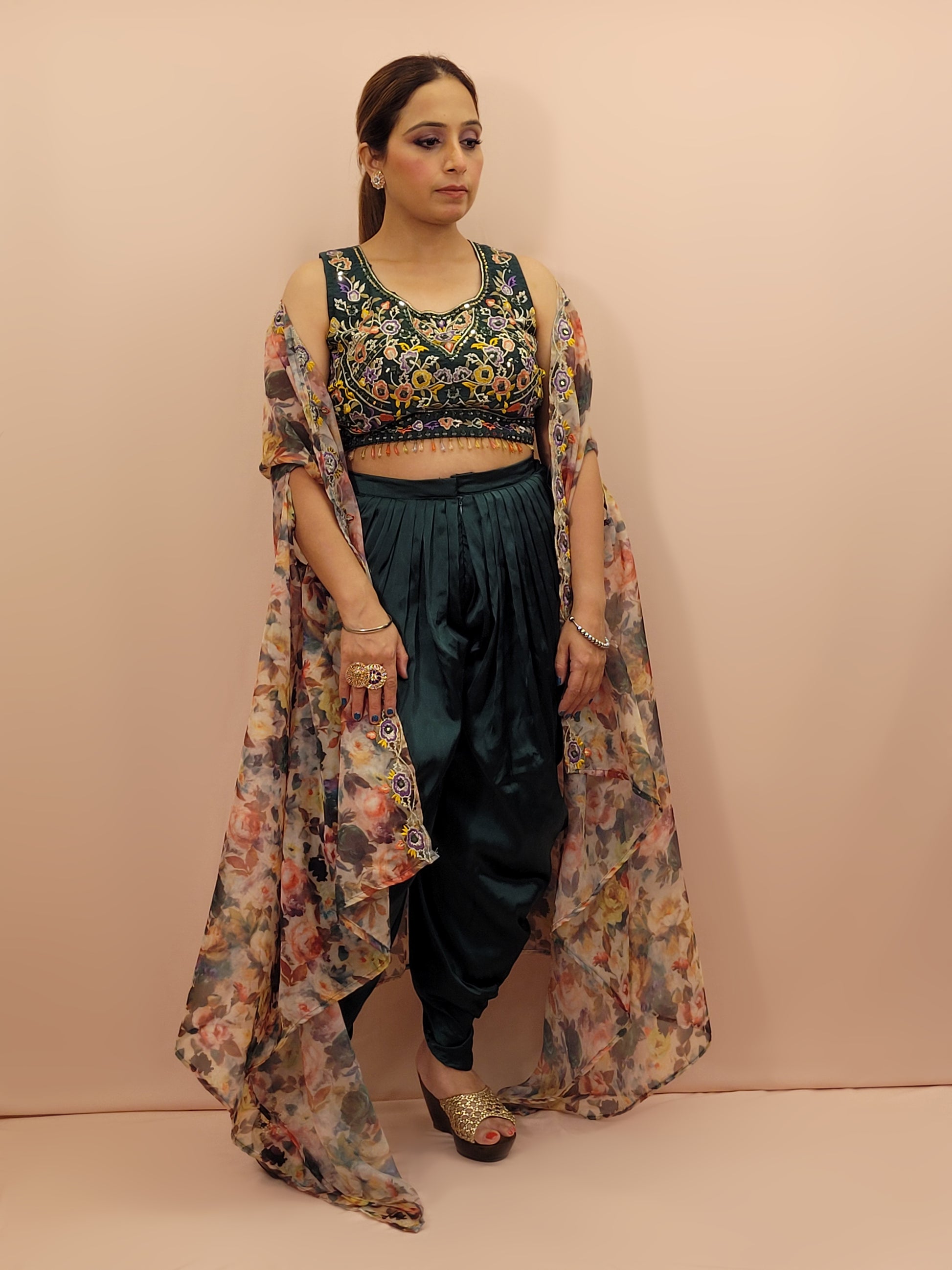 The blouse is adorned with vibrant resham embroidery, creating a tapestry of traditional artistry on a contemporary silhouette. The tulip pants provide a chic and comfortable fit, perfect for modern fashionistas. The digital multicolored print shrug adds a bold statement to the ensemble, with its vibrant hues and unique patterns.