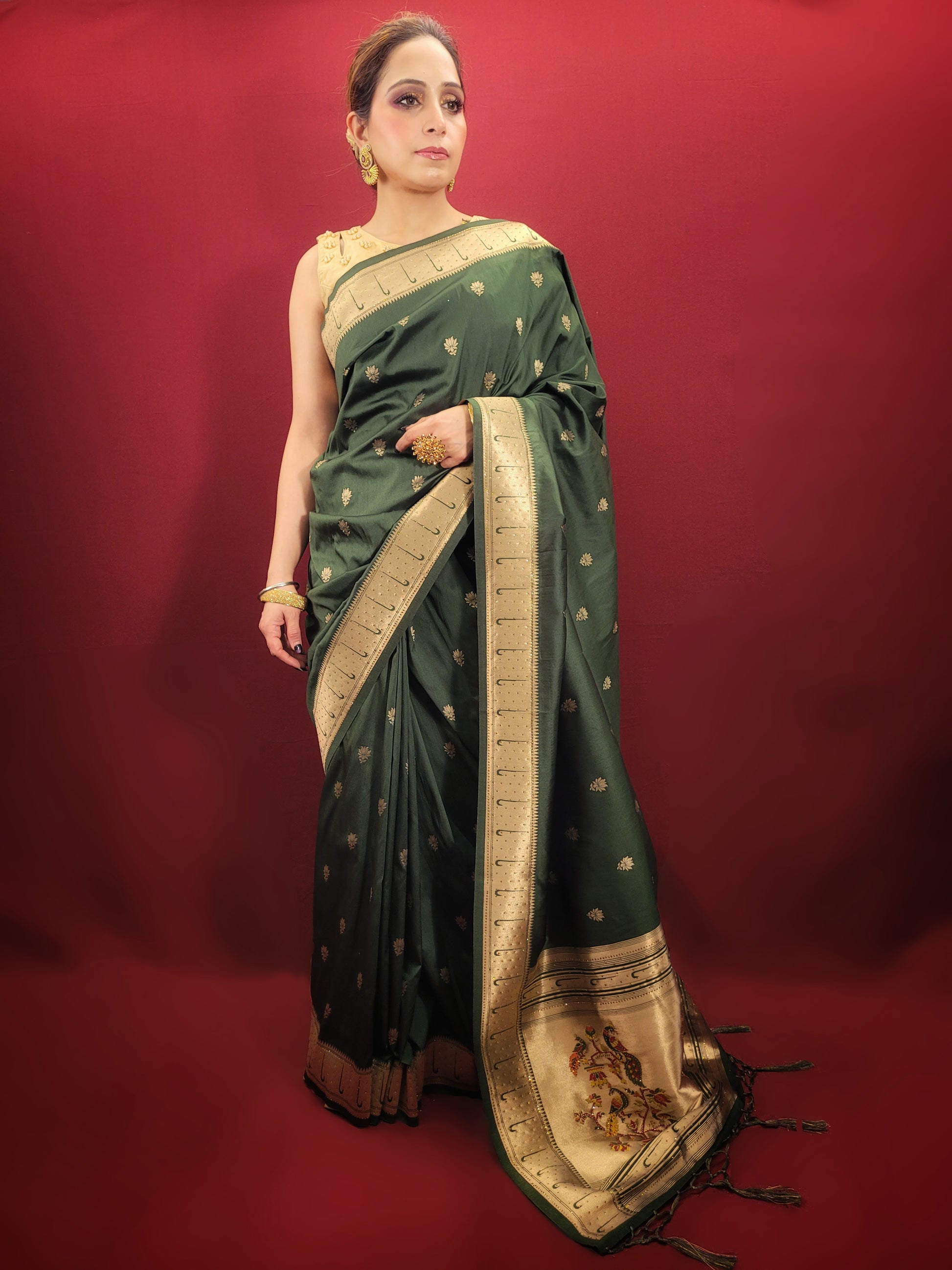 Adorn yourself with the timeless beauty of a bottle green Paithani Silk style Saree, masterfully woven to elevate your party and festive puja attire with its ethnic allure.