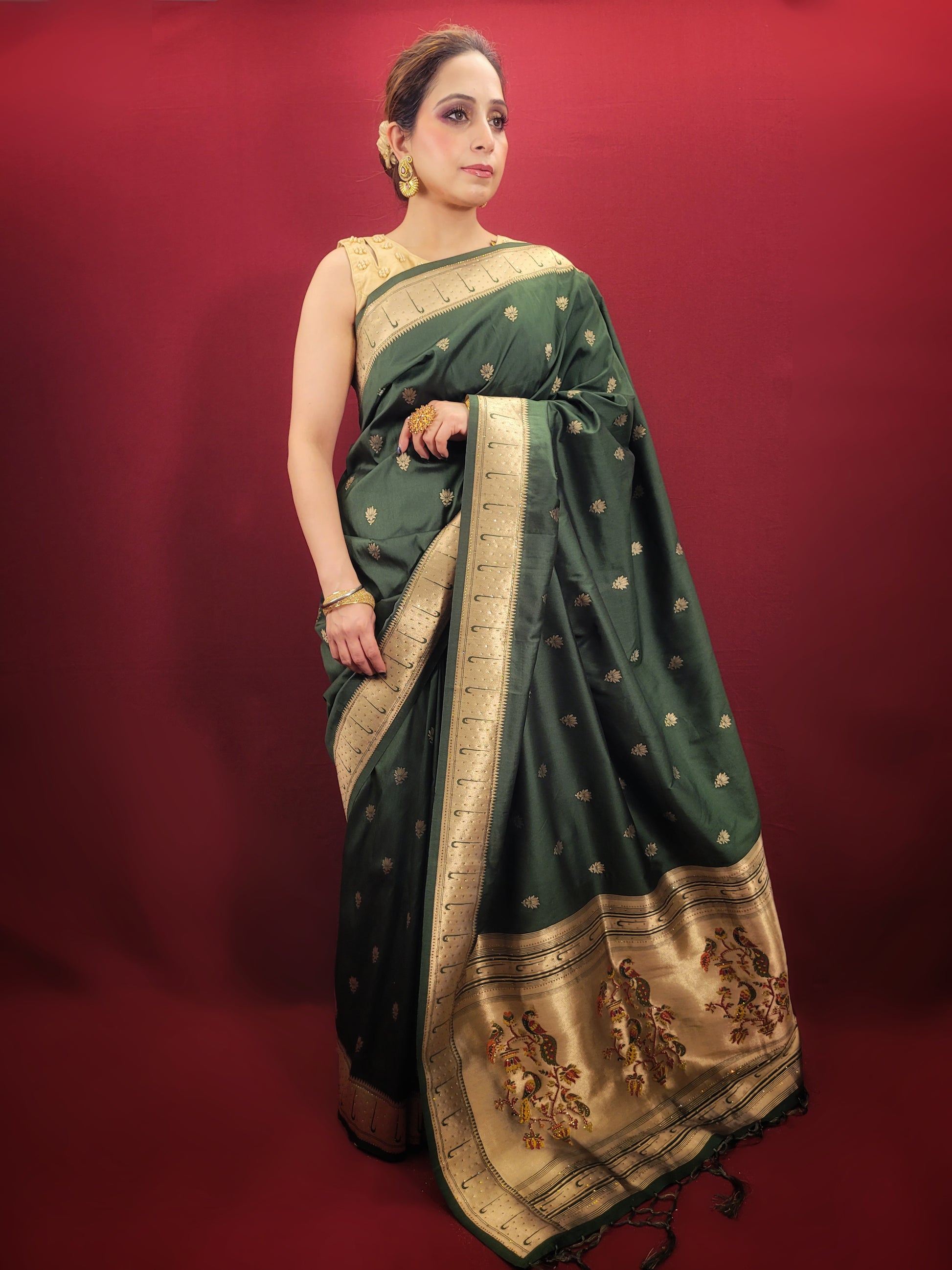 Adorn yourself with the timeless beauty of a bottle green Paithani Silk style Saree, masterfully woven to elevate your party and festive puja attire with its ethnic allure.