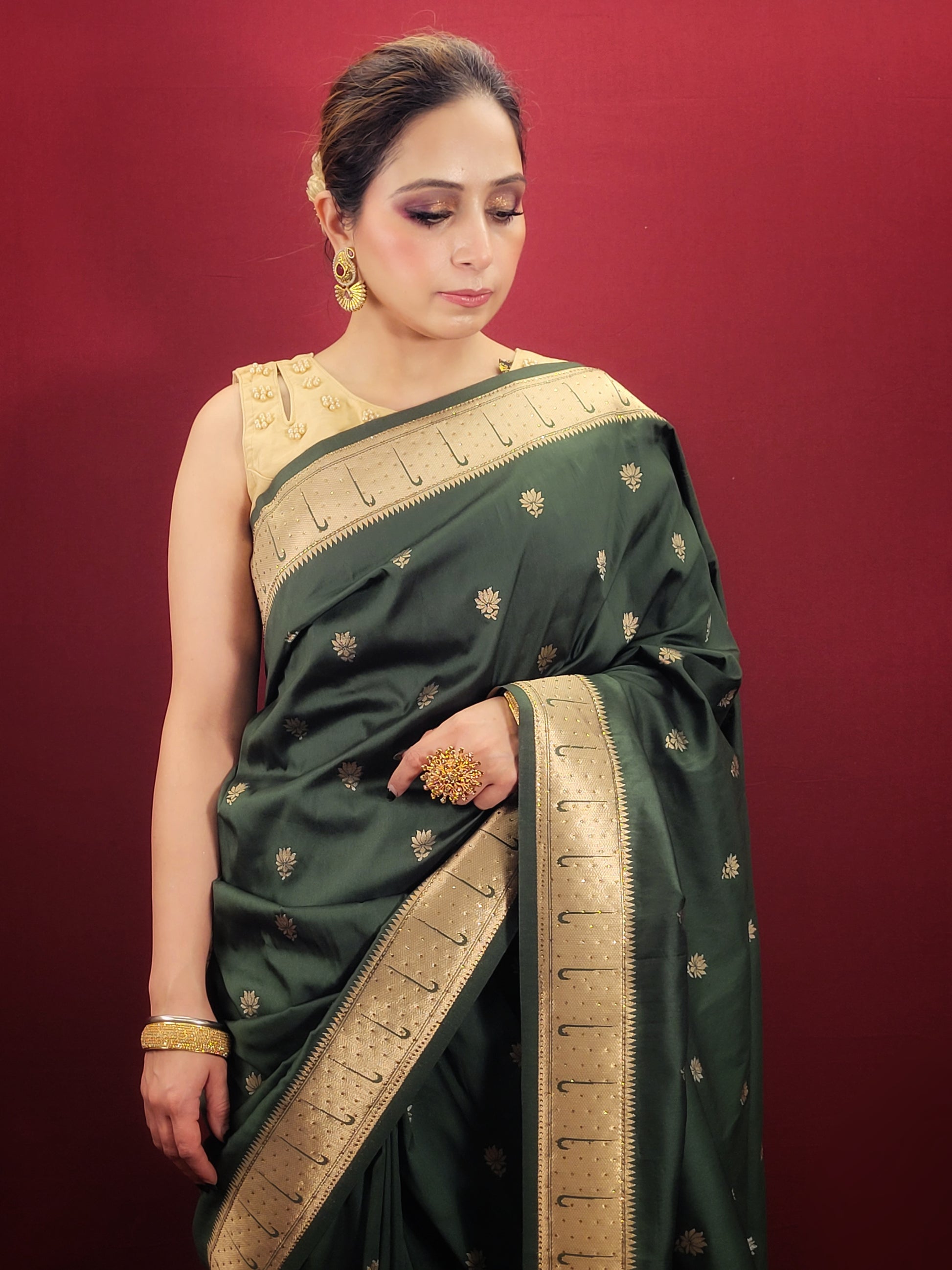 Adorn yourself with the timeless beauty of a bottle green Paithani Silk style Saree, masterfully woven to elevate your party and festive puja attire with its ethnic allure.