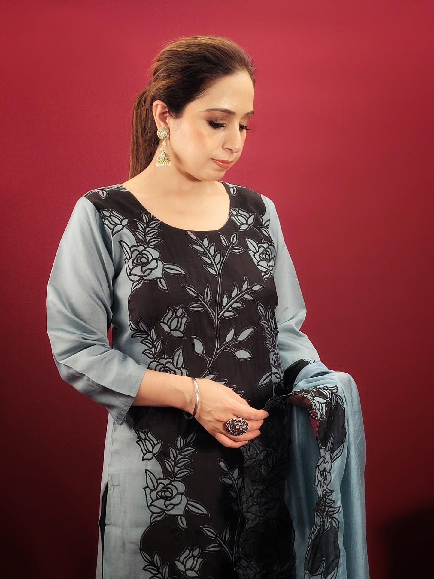 Embrace contemporary elegance with this stunning grey and black kurti pant dupatta set, perfect for light parties and festive soirees. This captivating ensemble features a unique interplay of colors and textures, making a bold statement without compromising on comfort.