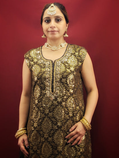 The Mehendi Green Sharara Kameez set, paired with exclusive banarasi dupatta, and adorned with sequins, kundan and beads, is a georgette masterpiece for wedding and party ethnic wear.