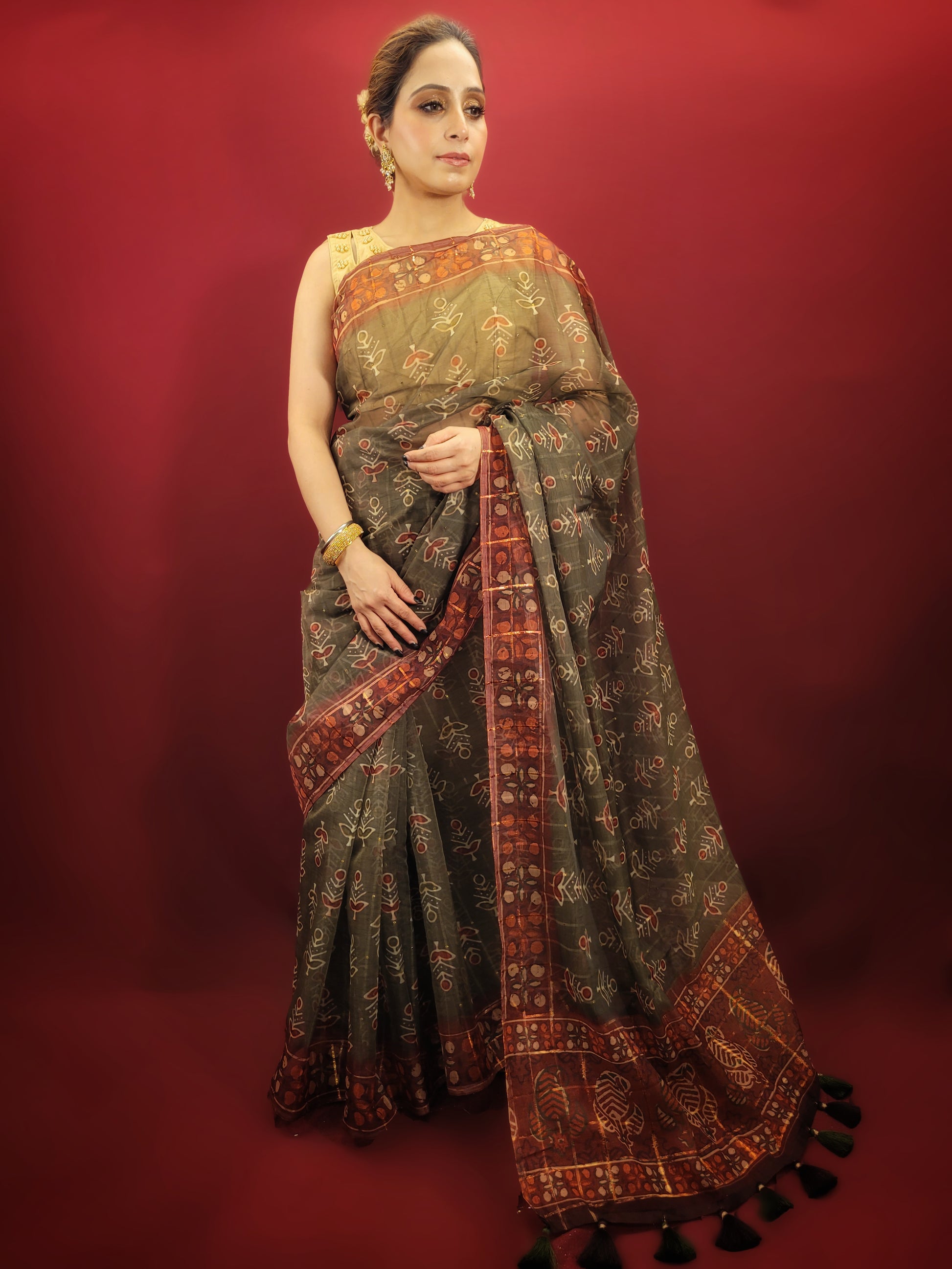 Embrace the grace of tradition with a mehendi green saree, adorned with exquisite organza and ajrakh prints, making it an ideal choice for party and festive wear.