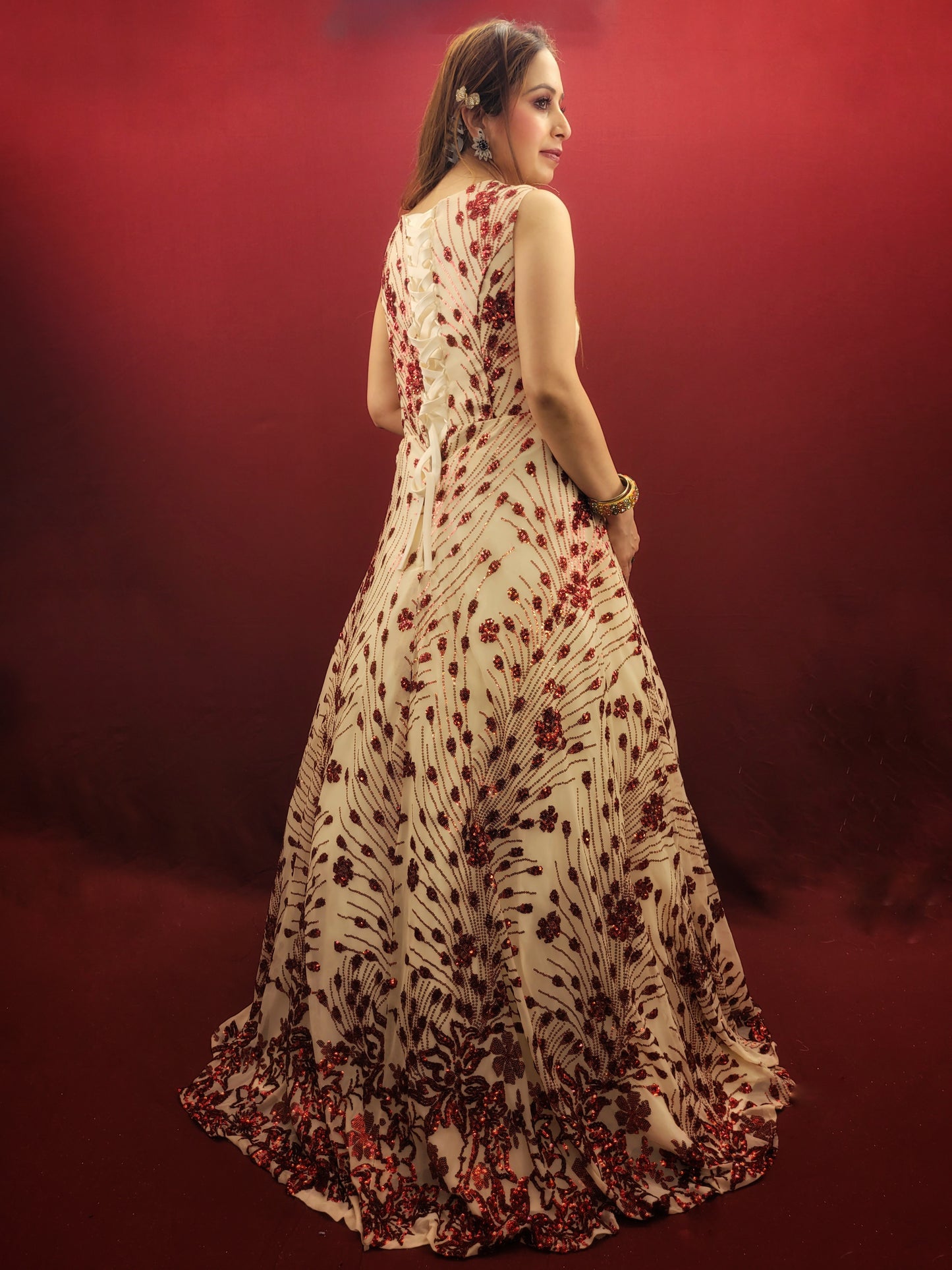 Step into the spotlight with an imported cream bridal gown, its red sequins catching the light with every step, ideal for your wedding, or as a dazzling choice for engagement and party wear.