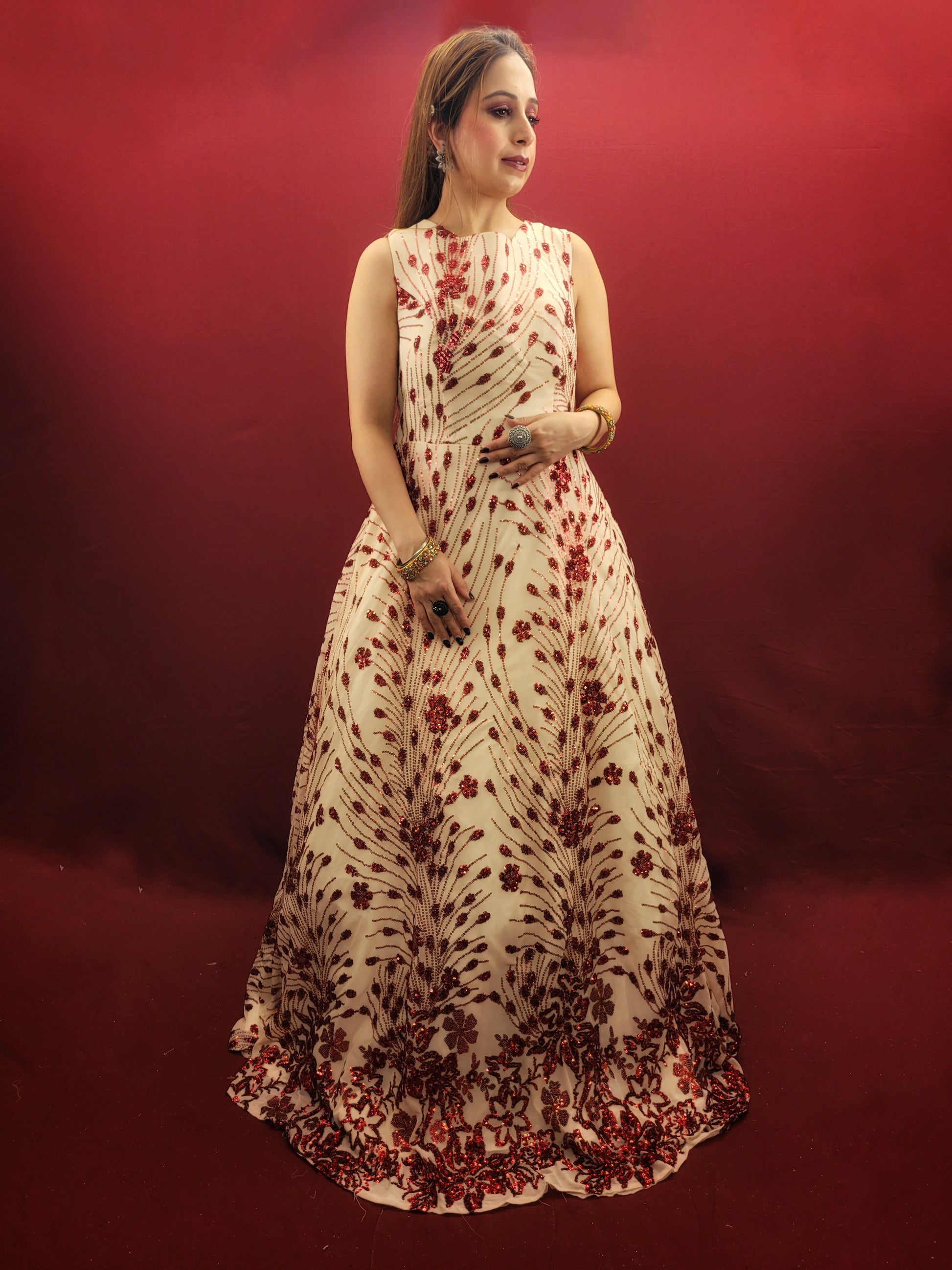 Step into the spotlight with an imported cream bridal gown, its red sequins catching the light with every step, ideal for your wedding, or as a dazzling choice for engagement and party wear.