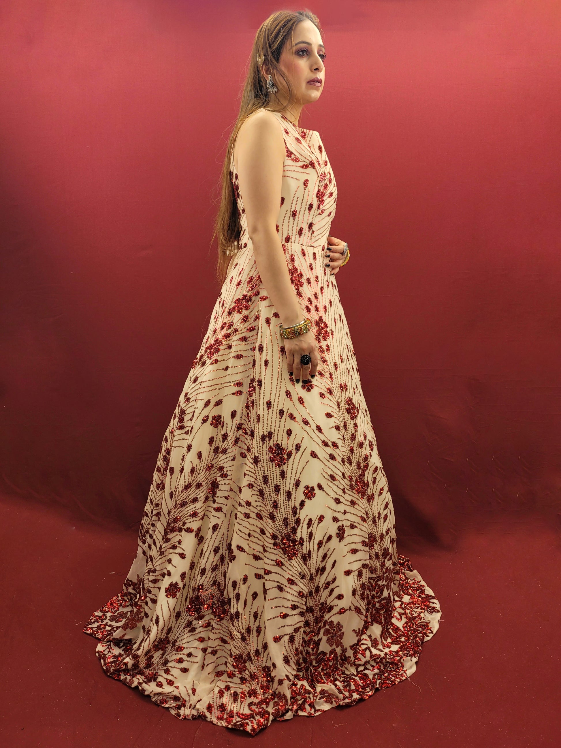Step into the spotlight with an imported cream bridal gown, its red sequins catching the light with every step, ideal for your wedding, or as a dazzling choice for engagement and party wear.