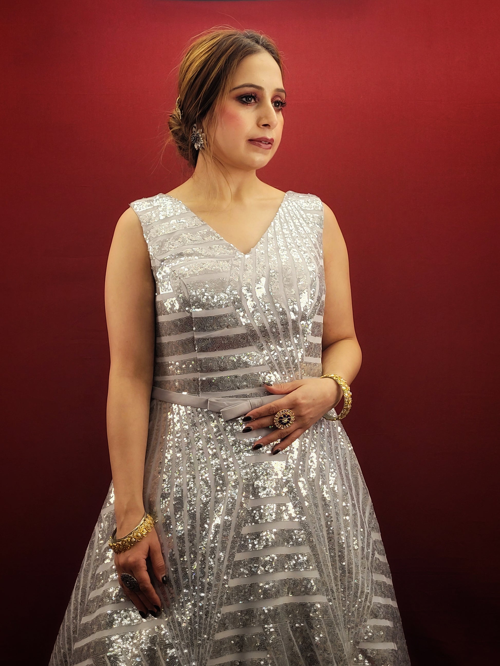 Envision a silver grey bridal gown, in imported fabric and embellished with shimmering sequins, designed to be the center-piece of your wedding, engagement, or reception party.