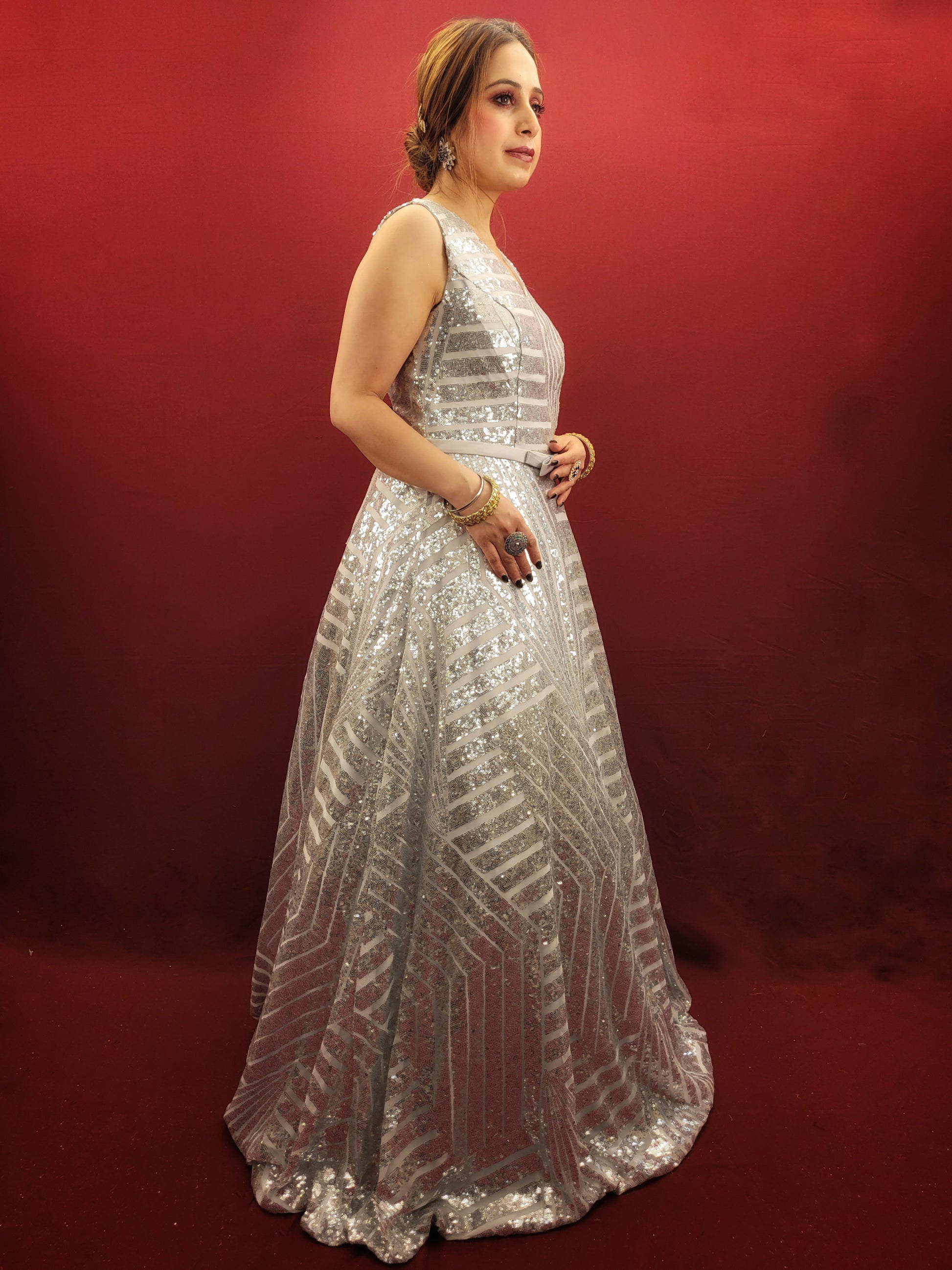 Envision a silver grey bridal gown, in imported fabric and embellished with shimmering sequins, designed to be the center-piece of your wedding, engagement, or reception party.