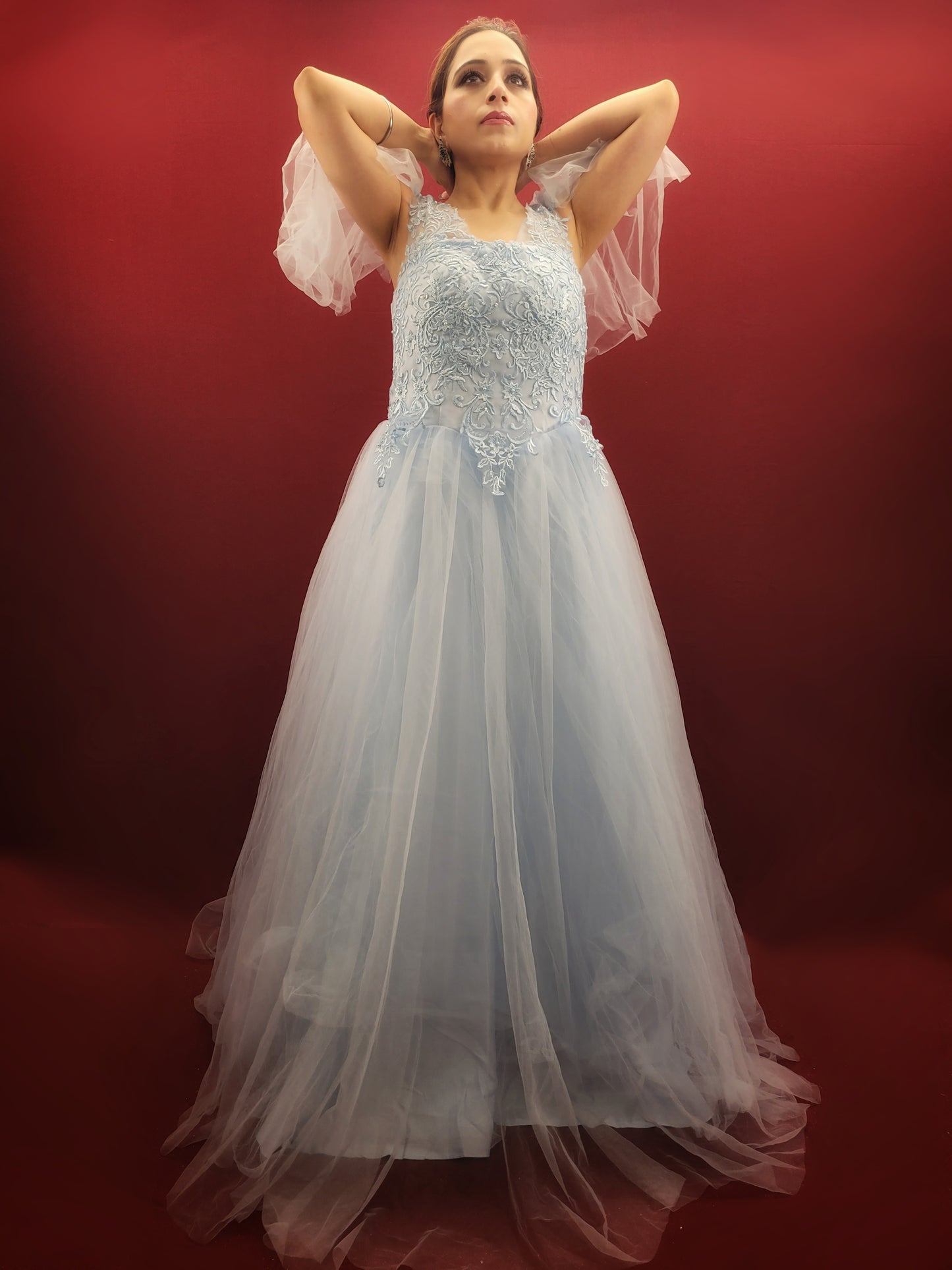 Imagine a sky blue net ball gown, graced with intricate lacework, that flows like a barbie dream, making it an enchanting selection for weddings, engagements, and parties.