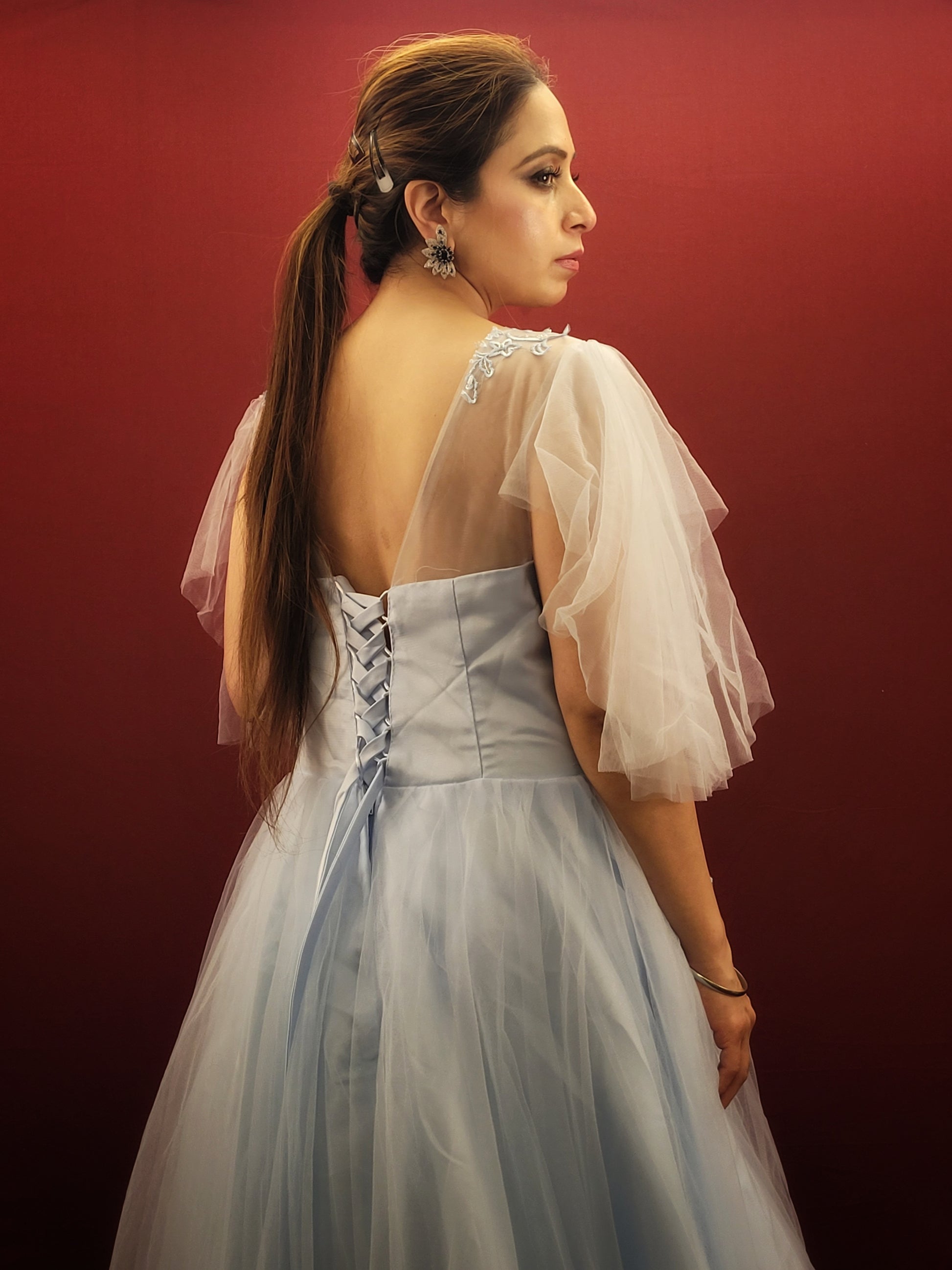 Imagine a sky blue net ball gown, graced with intricate lacework, that flows like a barbie dream, making it an enchanting selection for weddings, engagements, and parties.