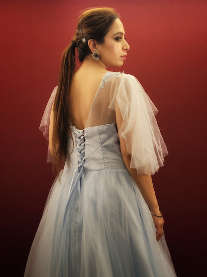 Imagine a sky blue net ball gown, graced with intricate lacework, that flows like a barbie dream, making it an enchanting selection for weddings, engagements, and parties.