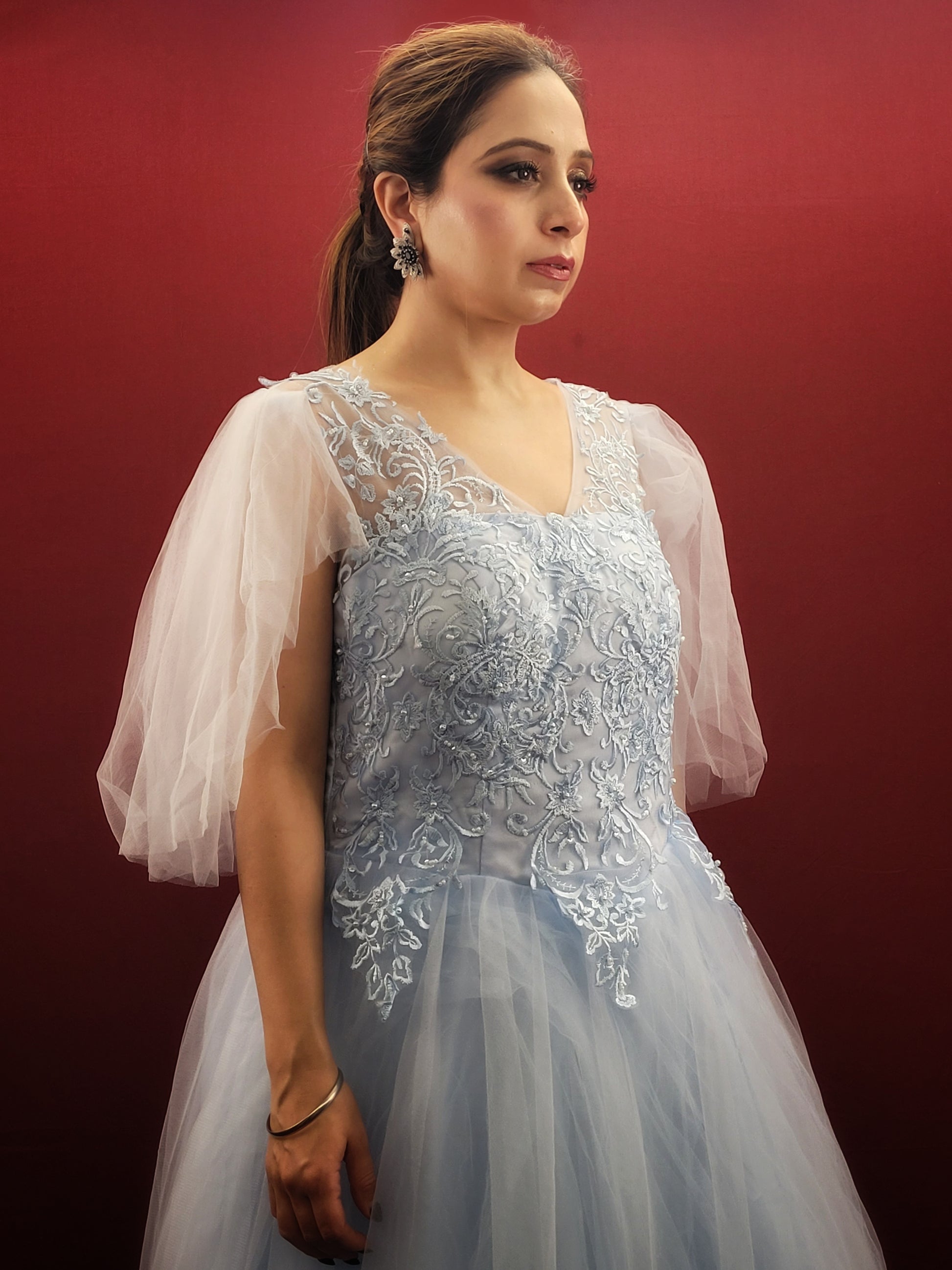 Imagine a sky blue net ball gown, graced with intricate lacework, that flows like a barbie dream, making it an enchanting selection for weddings, engagements, and parties.