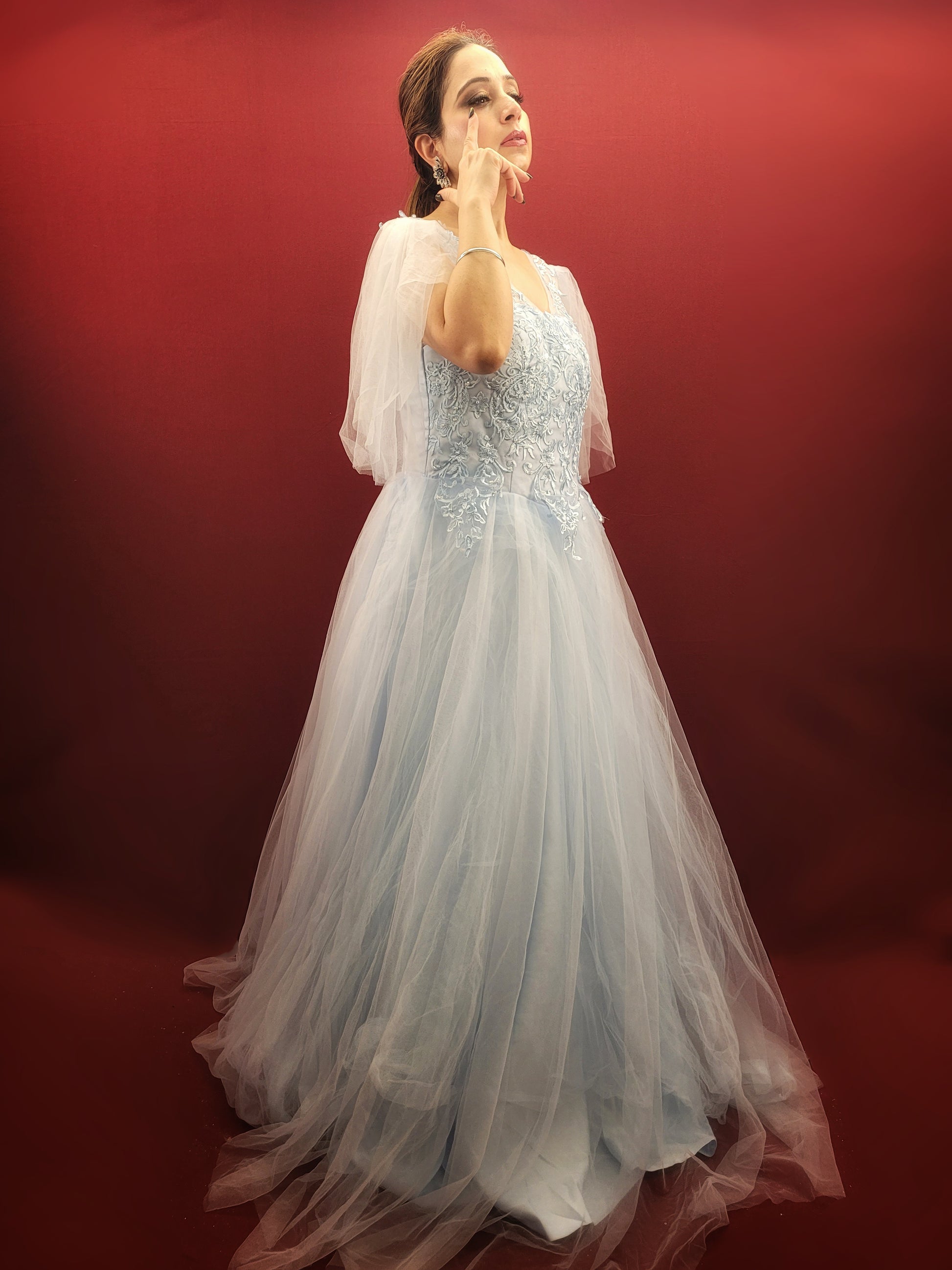 Imagine a sky blue net ball gown, graced with intricate lacework, that flows like a barbie dream, making it an enchanting selection for weddings, engagements, and parties.