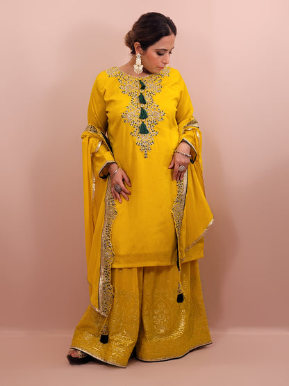 Yellow sharara suit with zari and resham neckline. Bichitra Silk Kameez. Georgette Shrug with Zari and Resham work border. Georgette Sharara wit Schiffli Work.