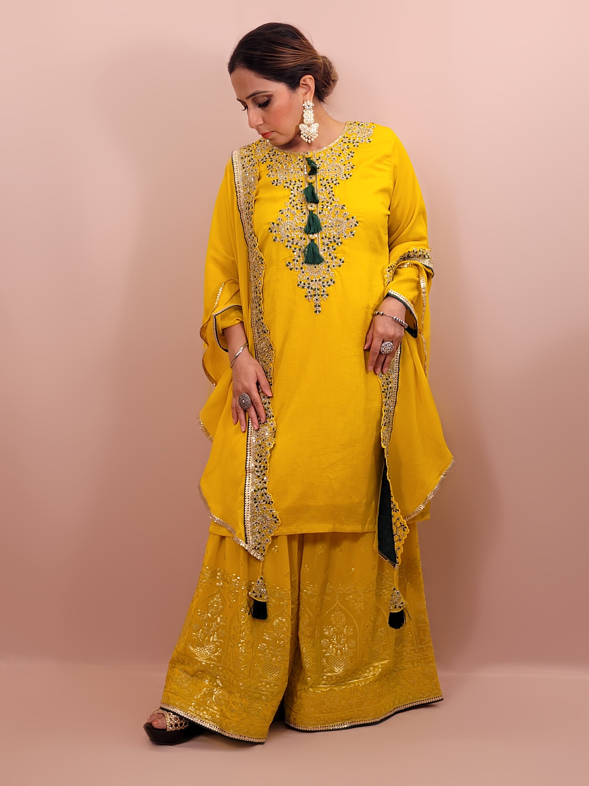 Yellow sharara suit with zari and resham neckline. Bichitra Silk Kameez. Georgette Shrug with Zari and Resham work border. Georgette Sharara wit Schiffli Work.