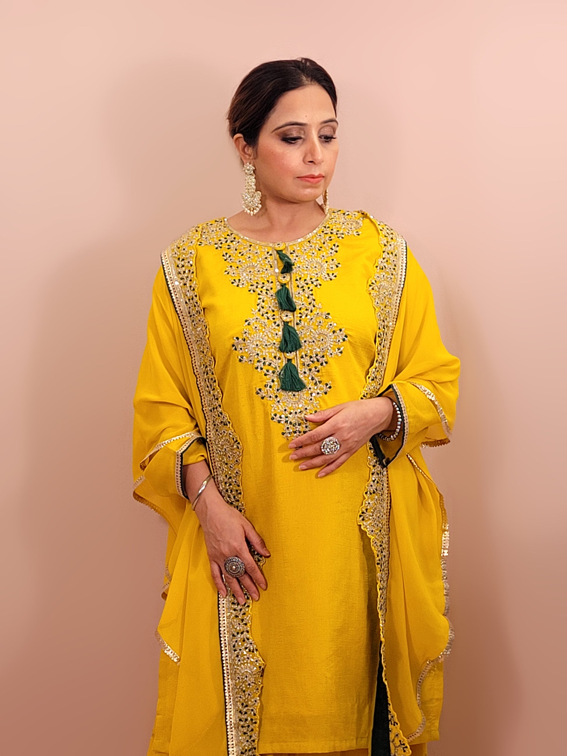 Yellow sharara suit with zari and resham neckline. Bichitra Silk Kameez. Georgette Shrug with Zari and Resham work border. Georgette Sharara wit Schiffli Work.