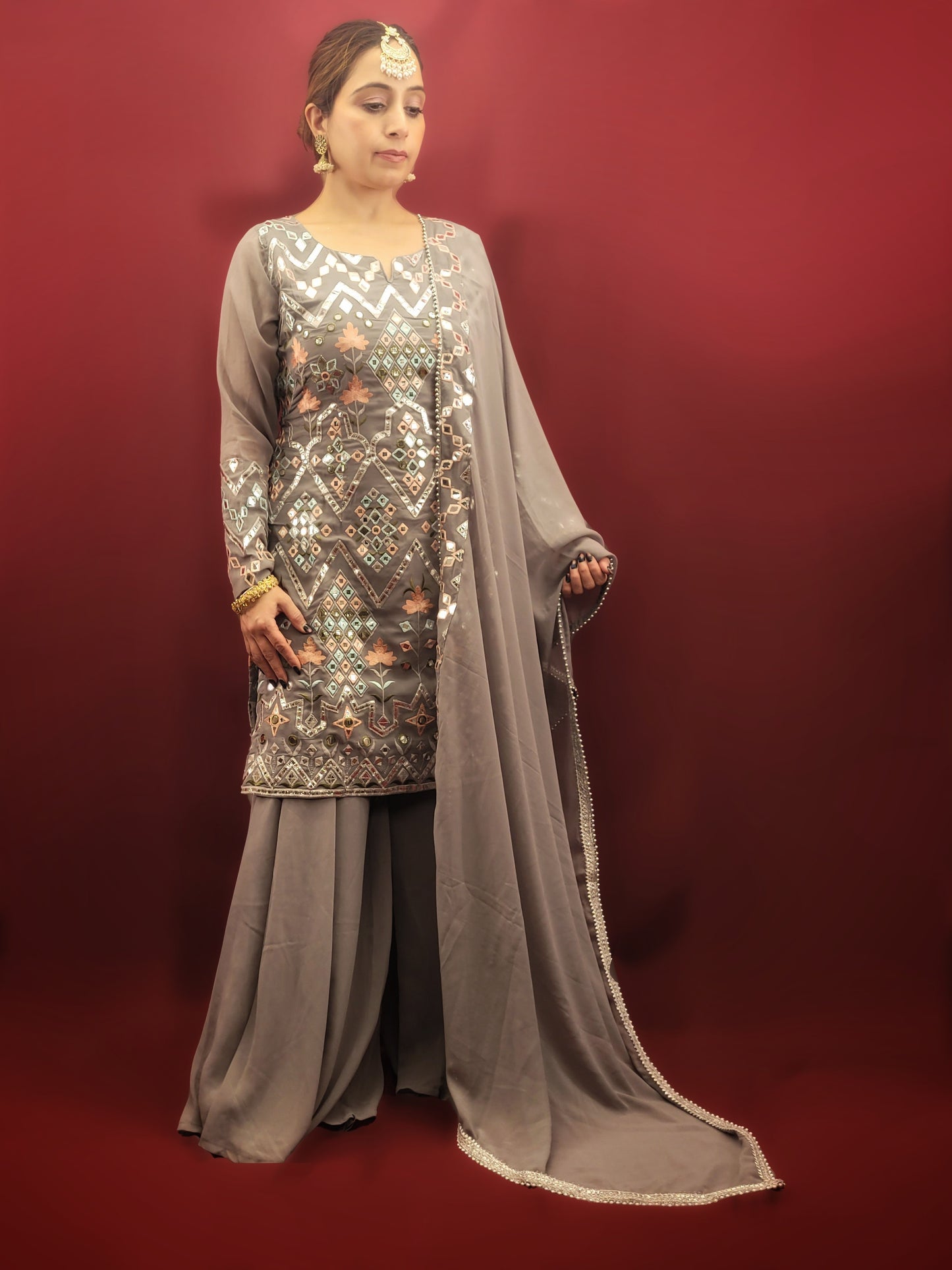 Embrace elegance with a light grey Indowestern Sharara set, meticulously crafted with foil and thread on georgette making it a sophisticated choice for any arty wear collection.