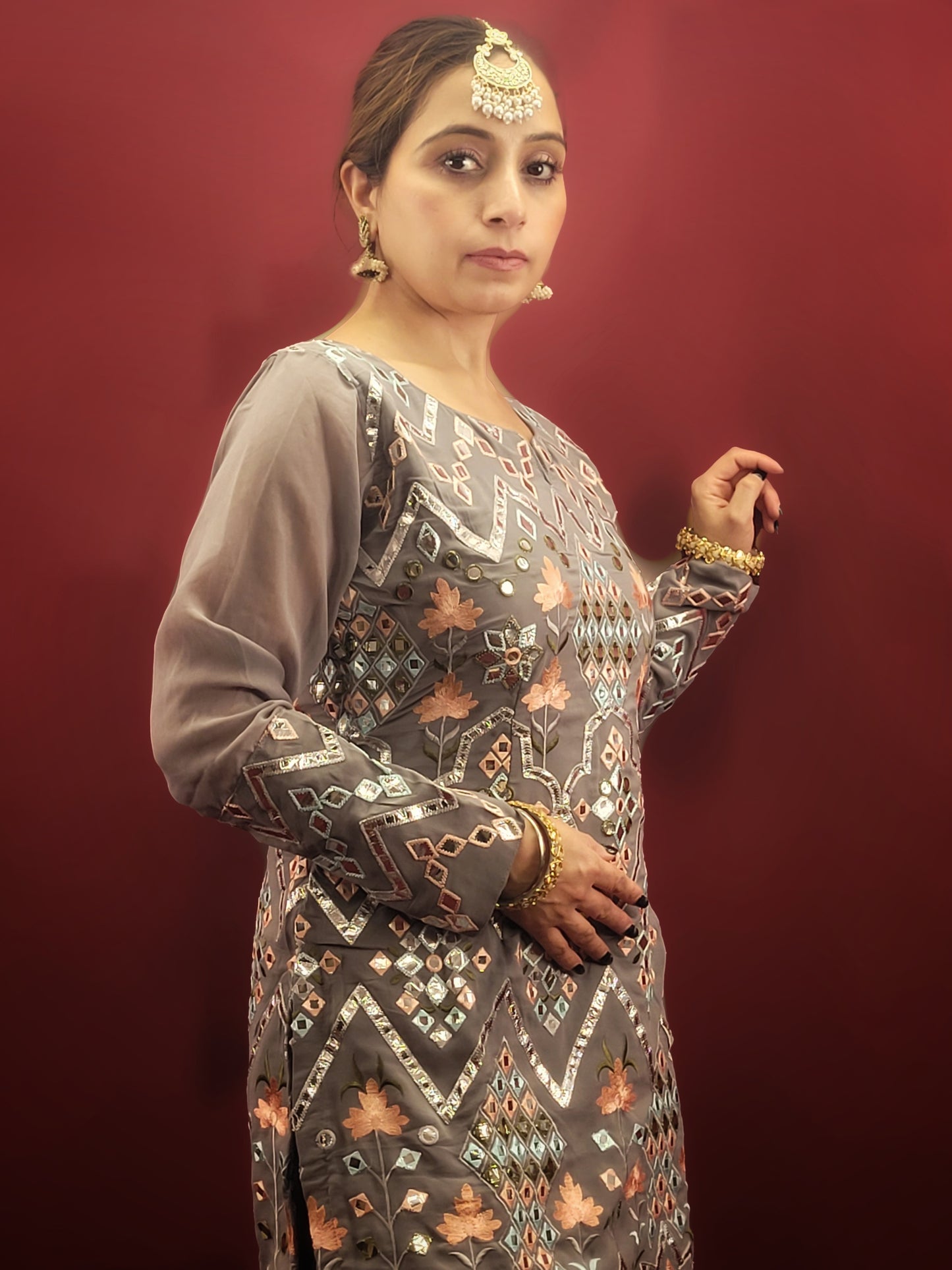 Embrace elegance with a light grey Indowestern Sharara set, meticulously crafted with foil and thread on georgette making it a sophisticated choice for any arty wear collection.