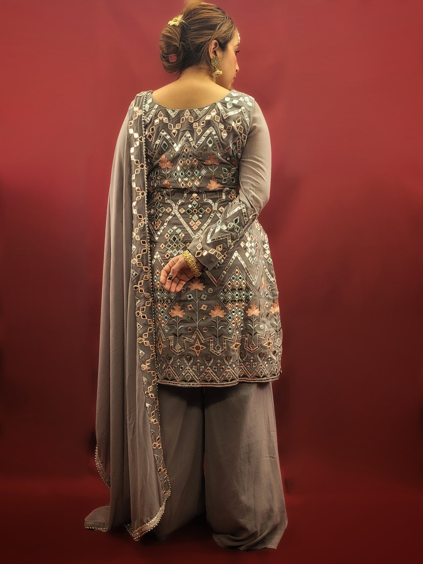 Embrace elegance with a light grey Indowestern Sharara set, meticulously crafted with foil and thread on georgette making it a sophisticated choice for any arty wear collection.