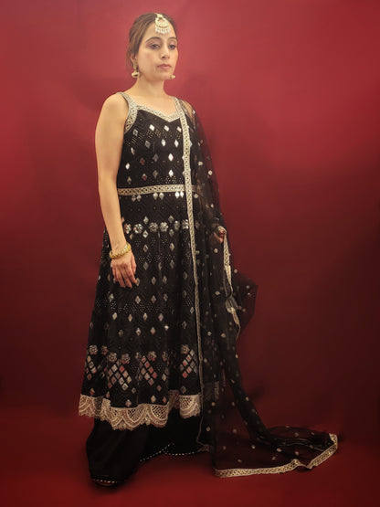 The black georgette sharara with an Anarkali, featuring foil mirror work, is a versatile ensemble that's ideal for a variety of occasions. It is perfect for weddings, festive celebrations, cocktail parties, and any event where Indian ethnic fusion is appreciated. It's elegance makes it a standout choice for making a sophisticated statement. 