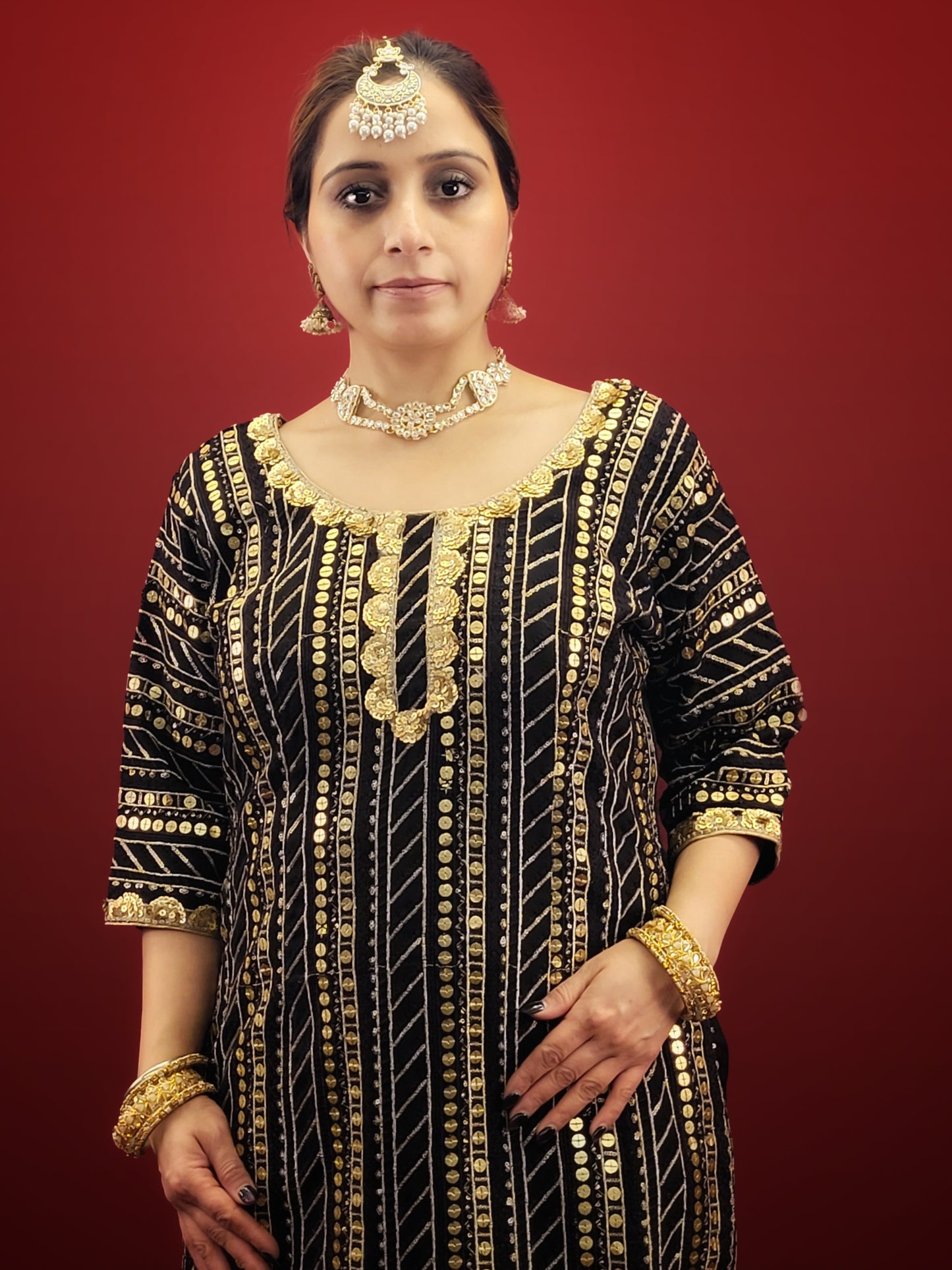 This black kameez and sharara set with sequins is perfect for a variety of occasions, from festive celebrations, to wedding events, making it a versatile choice for those seeking a blend of traditional and indo-western ethnic wear. It is ideal for adding a touch of glamour to any special occasion.