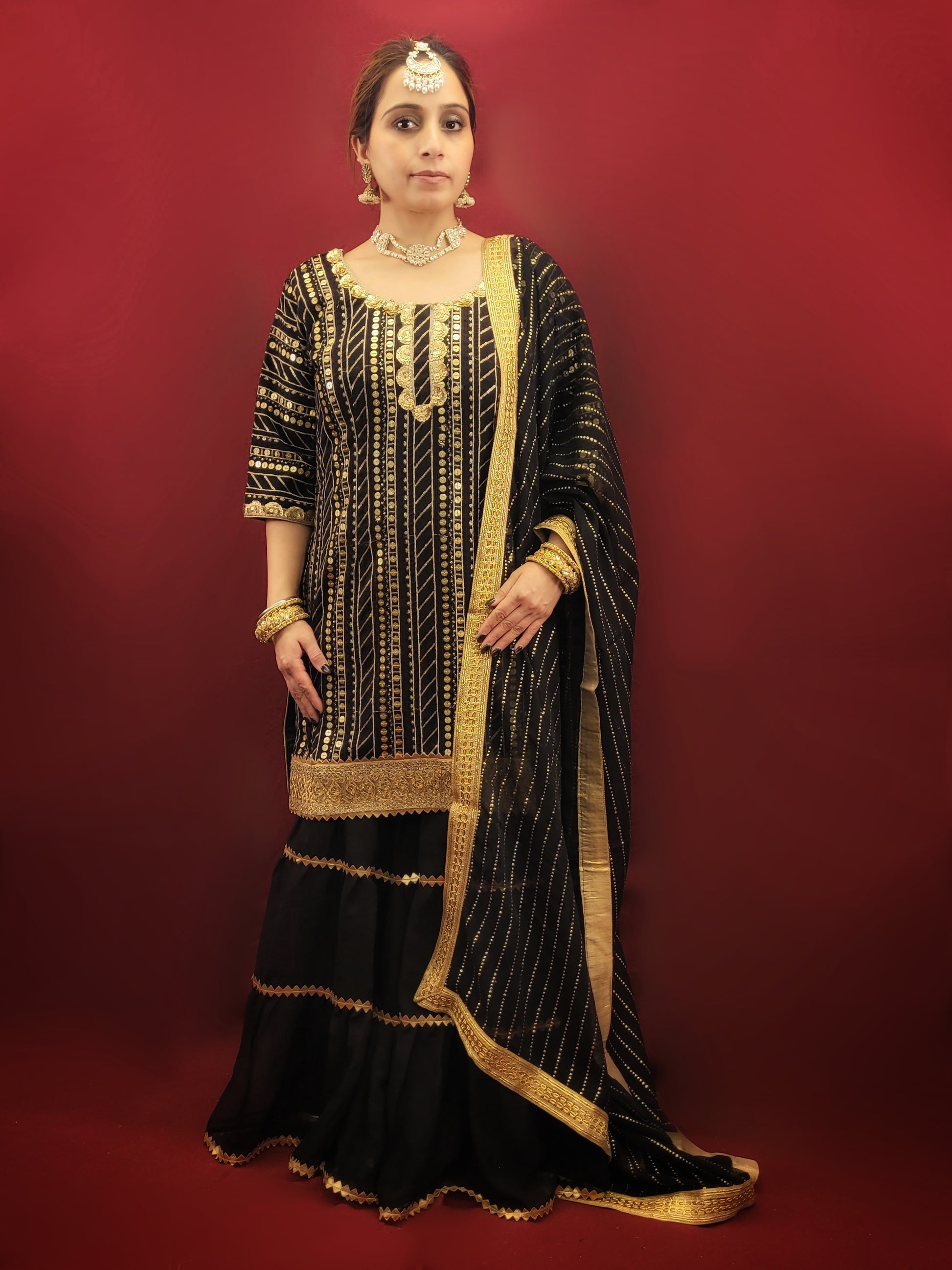 This black kameez and sharara set with sequins is perfect for a variety of occasions, from festive celebrations, to wedding events, making it a versatile choice for those seeking a blend of traditional and indo-western ethnic wear. It is ideal for adding a touch of glamour to any special occasion.