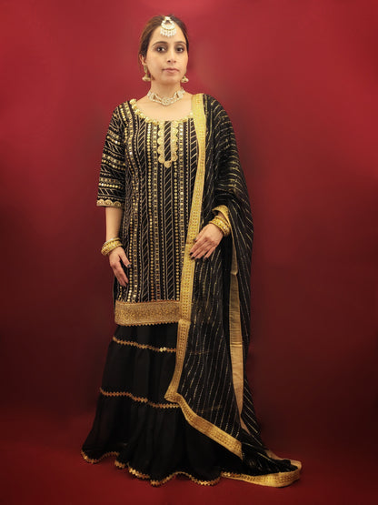 This black kameez and sharara set with sequins is perfect for a variety of occasions, from festive celebrations, to wedding events, making it a versatile choice for those seeking a blend of traditional and indo-western ethnic wear. It is ideal for adding a touch of glamour to any special occasion.
