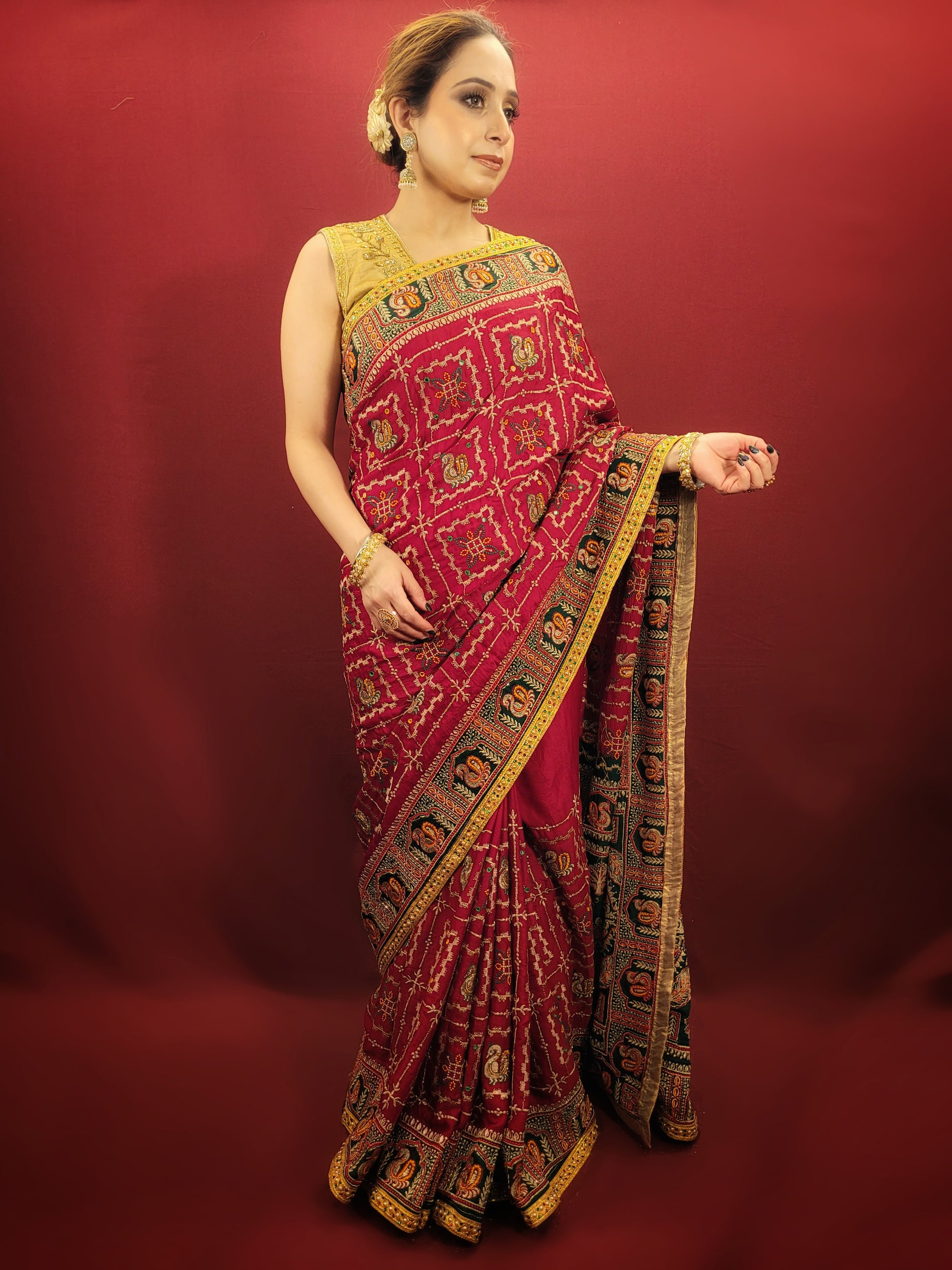 Take a look at this stunning maroon red ethnic saree with a green pallu that's perfect for weddings and bridal wear. The saree is made of gajji silk fabric and features intricate work using cutdana, thread, and zari. It's a beautiful piece that will surely catch everyone's eye.