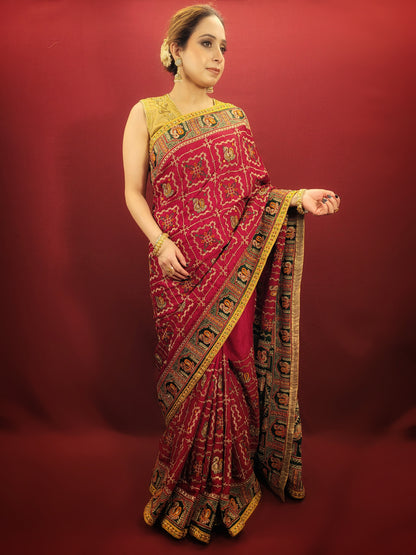 Take a look at this stunning maroon red ethnic saree with a green pallu that's perfect for weddings and bridal wear. The saree is made of gajji silk fabric and features intricate work using cutdana, thread, and zari. It's a beautiful piece that will surely catch everyone's eye.