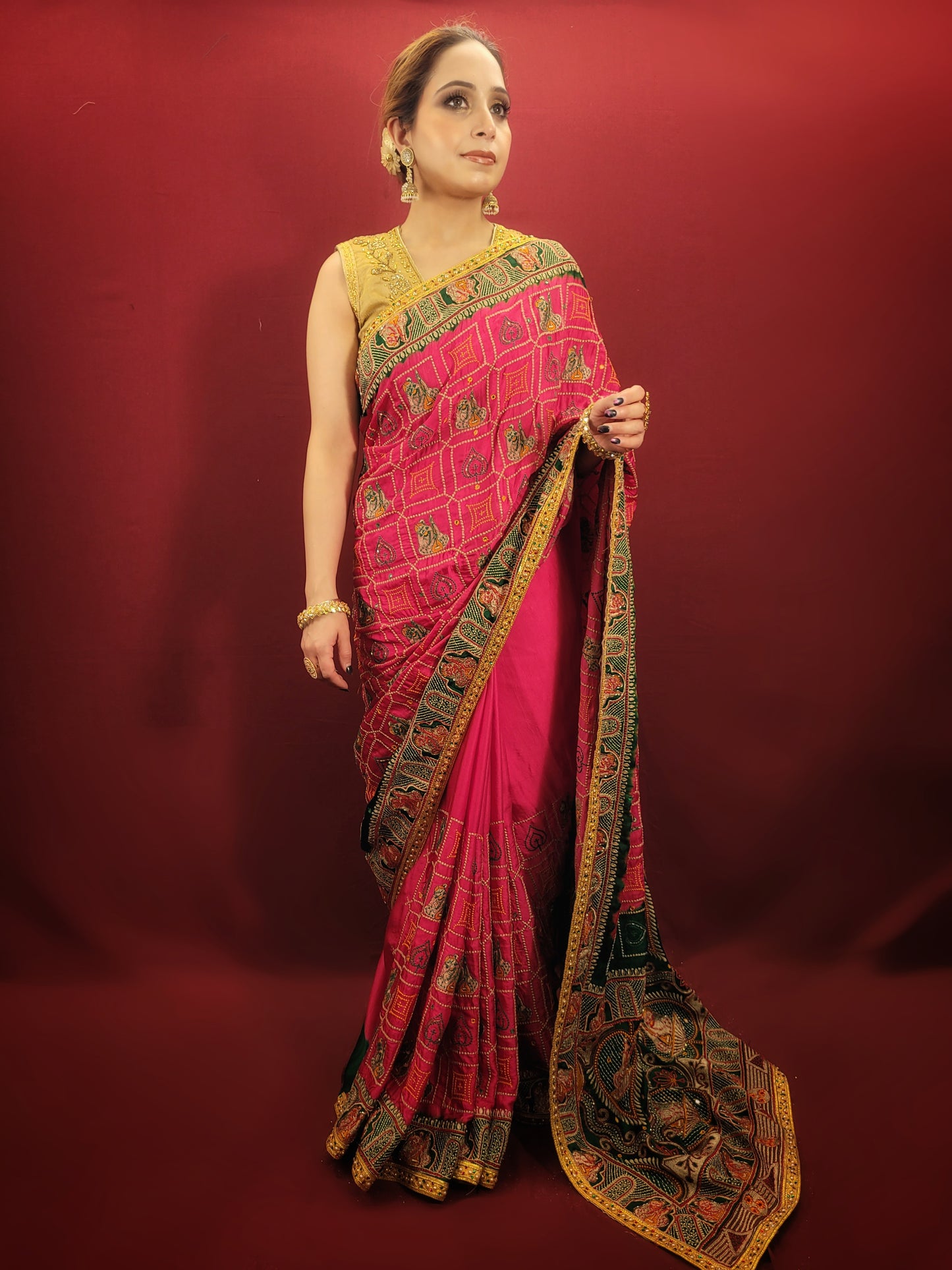 Beautiful Rani Pink Gajji Silk Bridal Saree with a gorgeous green pallu that would be perfect for the upcoming wedding season. The saree is embellished with intricate cutdana, zari, and threadwork that truly make it stand out. The silk material gives it a luxurious feel that's sure to make you feel like royalty on your big day. 