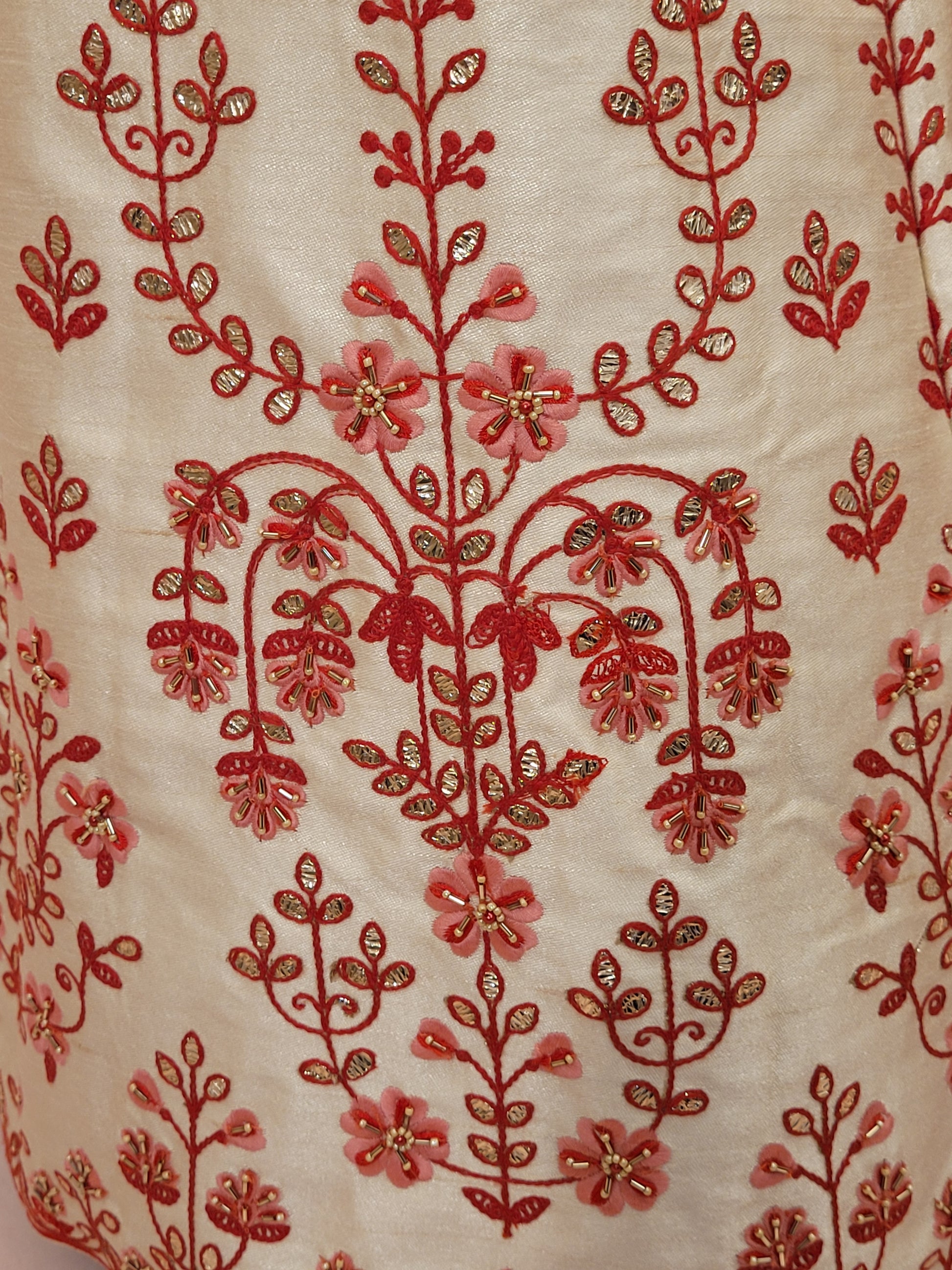 Immerse yourself in the elegance of Indian tradition with this exquisite Cream color silk unstitched lehenga, inspired by the renowned designer Anita Dongre. This lehenga is a true masterpiece, featuring intricate resham embroidery and delicate beads work that beautifully adorns the luxurious silk fabric, creating a captivating and sophisticated look.