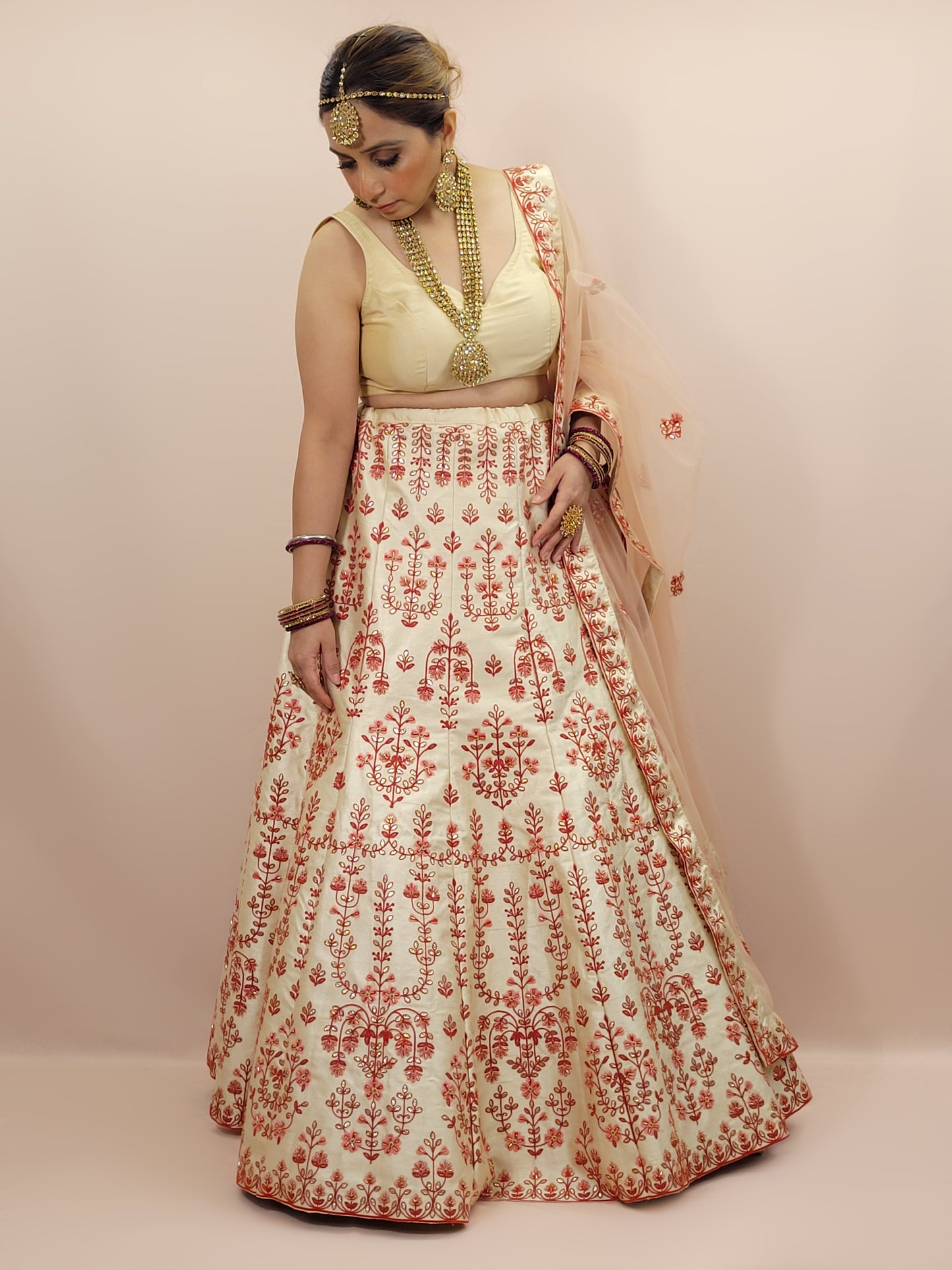 Immerse yourself in the elegance of Indian tradition with this exquisite Cream color silk unstitched lehenga, inspired by the renowned designer Anita Dongre. This lehenga is a true masterpiece, featuring intricate resham embroidery and delicate beads work that beautifully adorns the luxurious silk fabric, creating a captivating and sophisticated look.