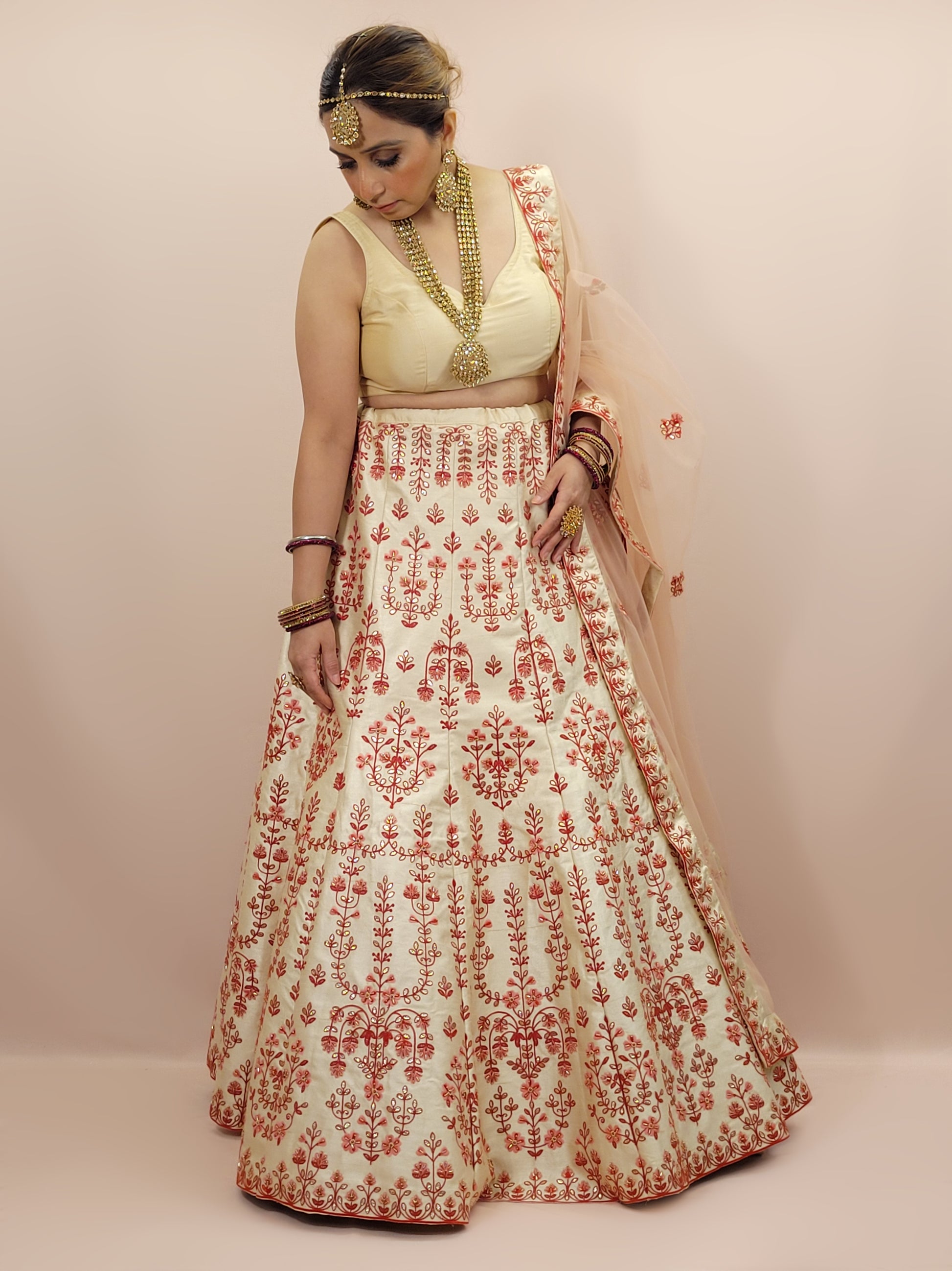 Immerse yourself in the elegance of Indian tradition with this exquisite Cream color silk unstitched lehenga, inspired by the renowned designer Anita Dongre. This lehenga is a true masterpiece, featuring intricate resham embroidery and delicate beads work that beautifully adorns the luxurious silk fabric, creating a captivating and sophisticated look.
