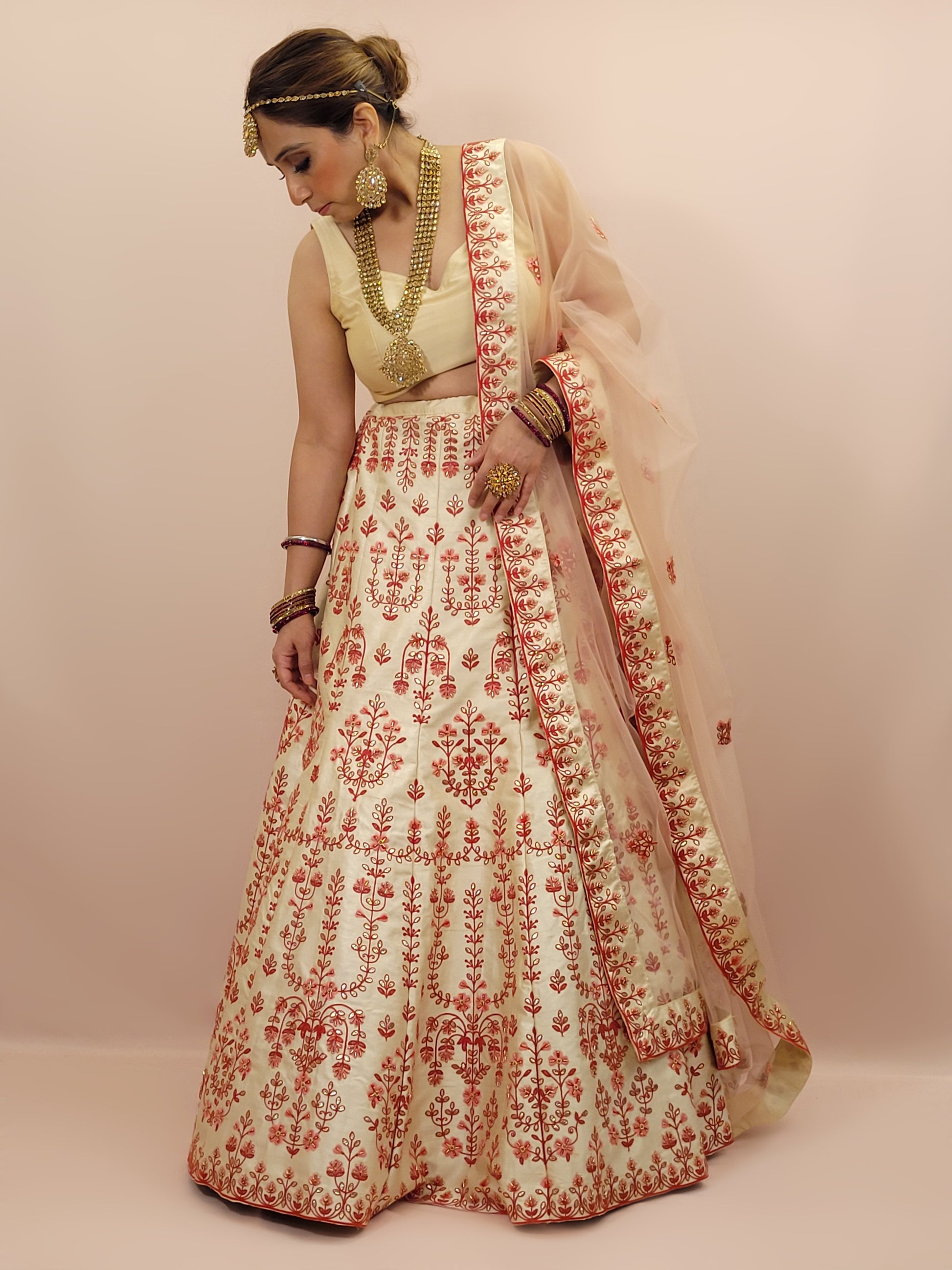 Immerse yourself in the elegance of Indian tradition with this exquisite Cream color silk unstitched lehenga, inspired by the renowned designer Anita Dongre. This lehenga is a true masterpiece, featuring intricate resham embroidery and delicate beads work that beautifully adorns the luxurious silk fabric, creating a captivating and sophisticated look.