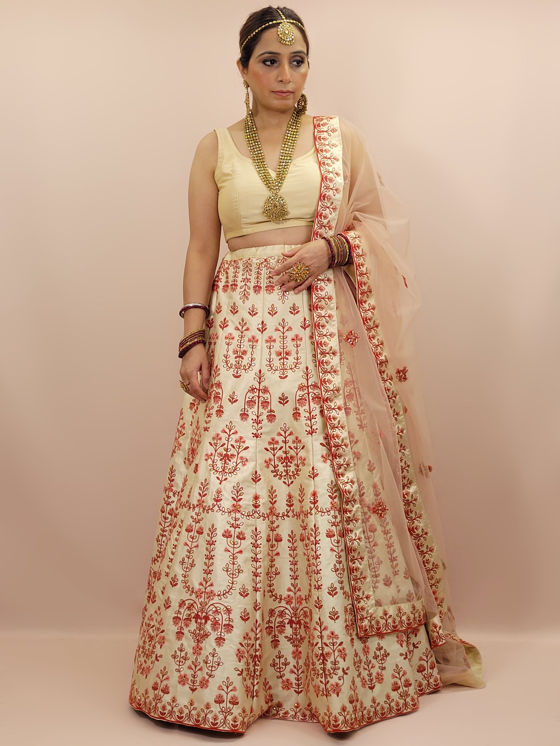 Immerse yourself in the elegance of Indian tradition with this exquisite Cream color silk unstitched lehenga, inspired by the renowned designer Anita Dongre. This lehenga is a true masterpiece, featuring intricate resham embroidery and delicate beads work that beautifully adorns the luxurious silk fabric, creating a captivating and sophisticated look.