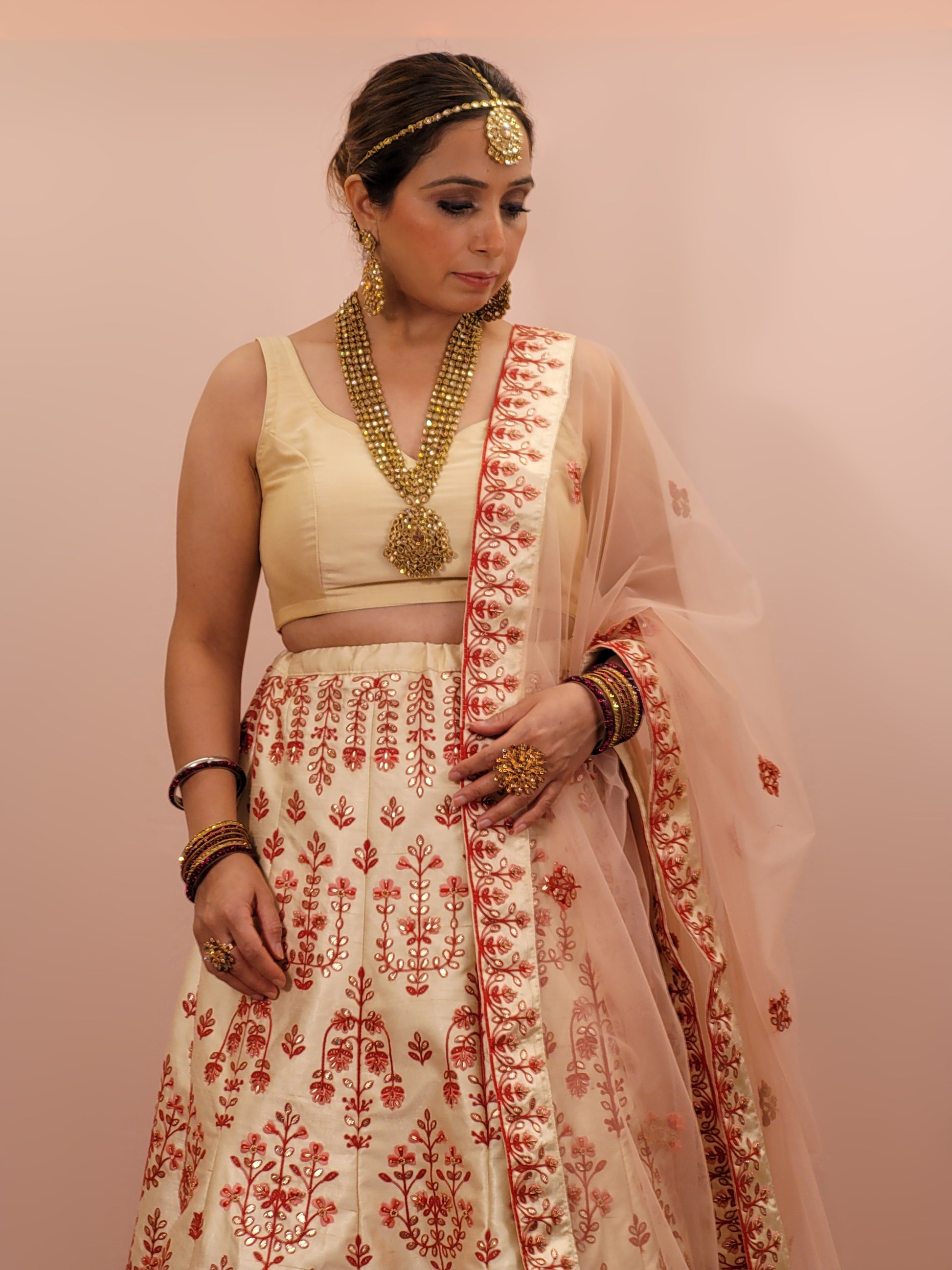 Immerse yourself in the elegance of Indian tradition with this exquisite Cream color silk unstitched lehenga, inspired by the renowned designer Anita Dongre. This lehenga is a true masterpiece, featuring intricate resham embroidery and delicate beads work that beautifully adorns the luxurious silk fabric, creating a captivating and sophisticated look.