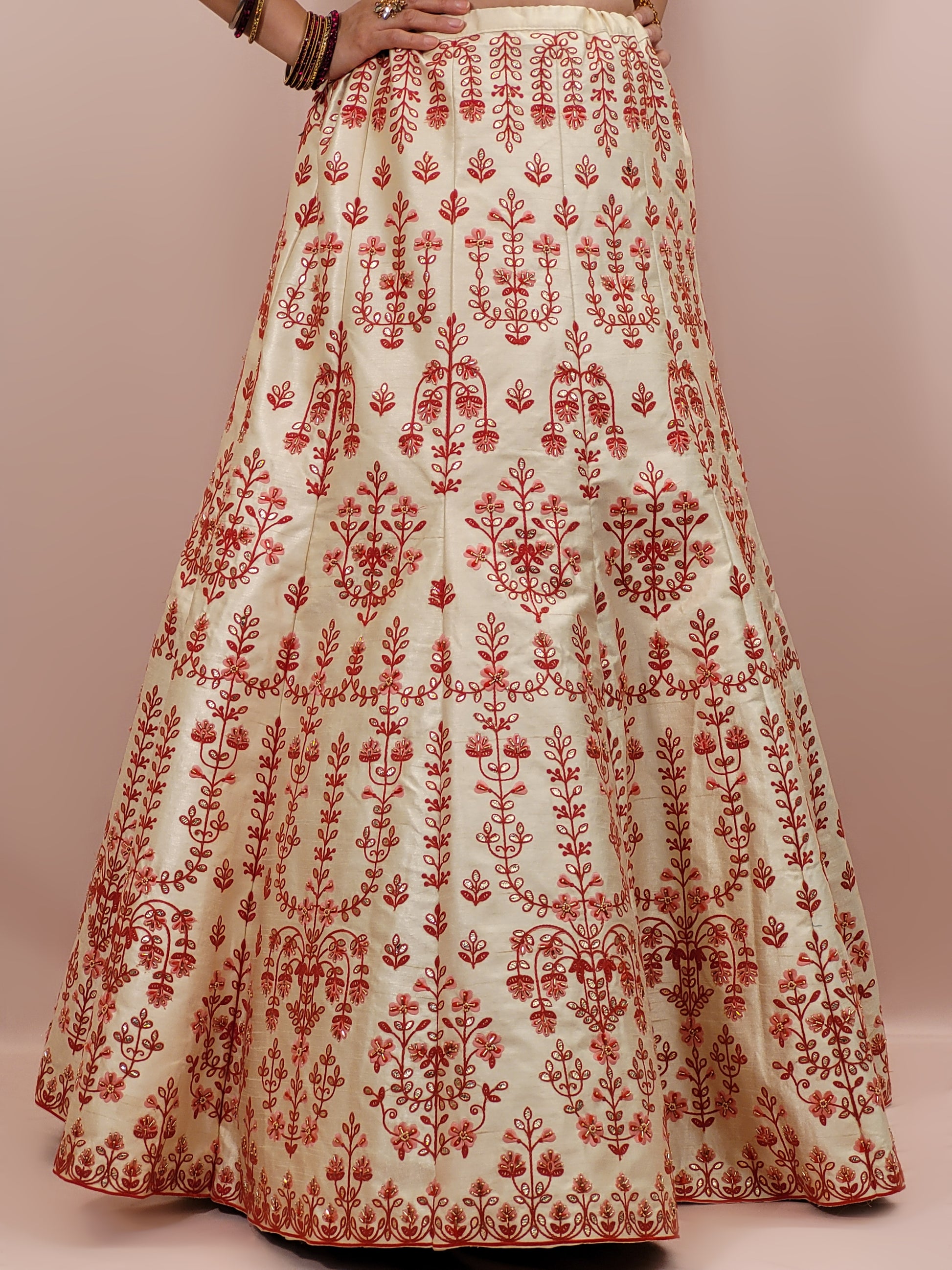 Immerse yourself in the elegance of Indian tradition with this exquisite Cream color silk unstitched lehenga, inspired by the renowned designer Anita Dongre. This lehenga is a true masterpiece, featuring intricate resham embroidery and delicate beads work that beautifully adorns the luxurious silk fabric, creating a captivating and sophisticated look.