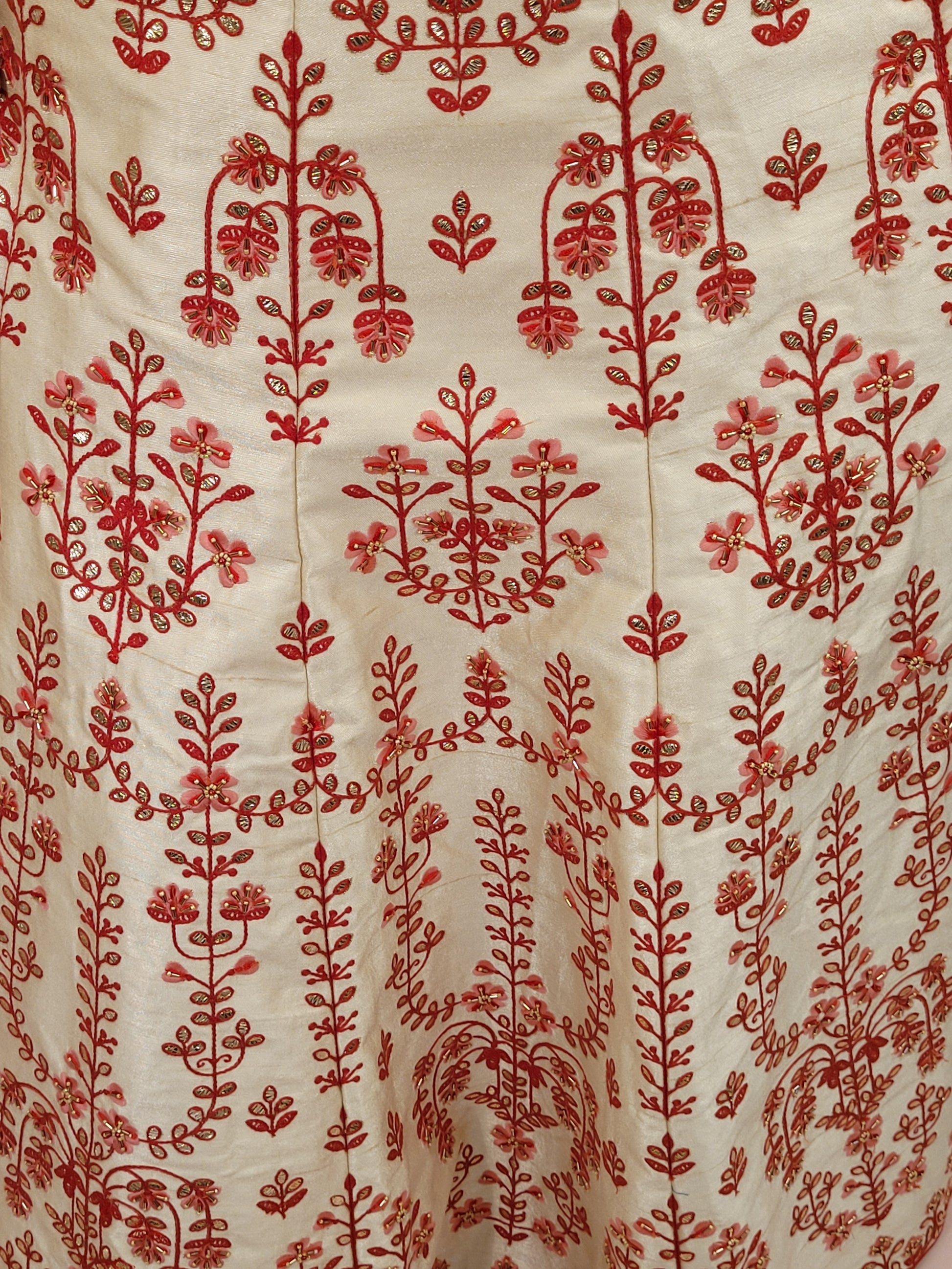 Immerse yourself in the elegance of Indian tradition with this exquisite Cream color silk unstitched lehenga, inspired by the renowned designer Anita Dongre. This lehenga is a true masterpiece, featuring intricate resham embroidery and delicate beads work that beautifully adorns the luxurious silk fabric, creating a captivating and sophisticated look.