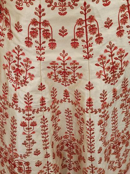 Immerse yourself in the elegance of Indian tradition with this exquisite Cream color silk unstitched lehenga, inspired by the renowned designer Anita Dongre. This lehenga is a true masterpiece, featuring intricate resham embroidery and delicate beads work that beautifully adorns the luxurious silk fabric, creating a captivating and sophisticated look.