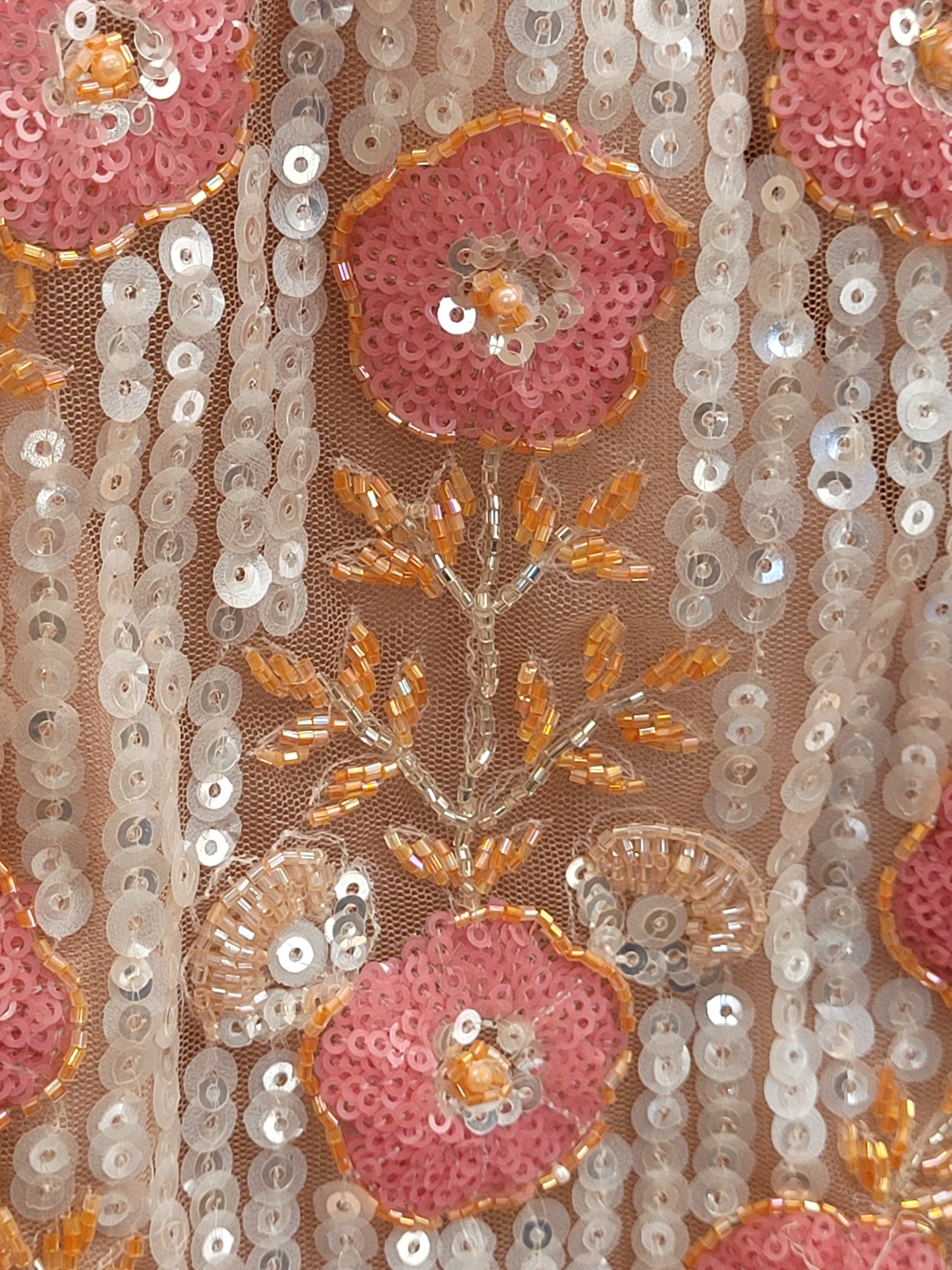 Elevate your ethnic wardrobe with this stunning ivory-colored net unstitched lehenga, a perfect blend of traditional craftsmanship and contemporary elegance. This lehenga is intricately adorned with shimmering water sequins and delicate glass beads work, creating a mesmerizing effect that catches the light with every movement.