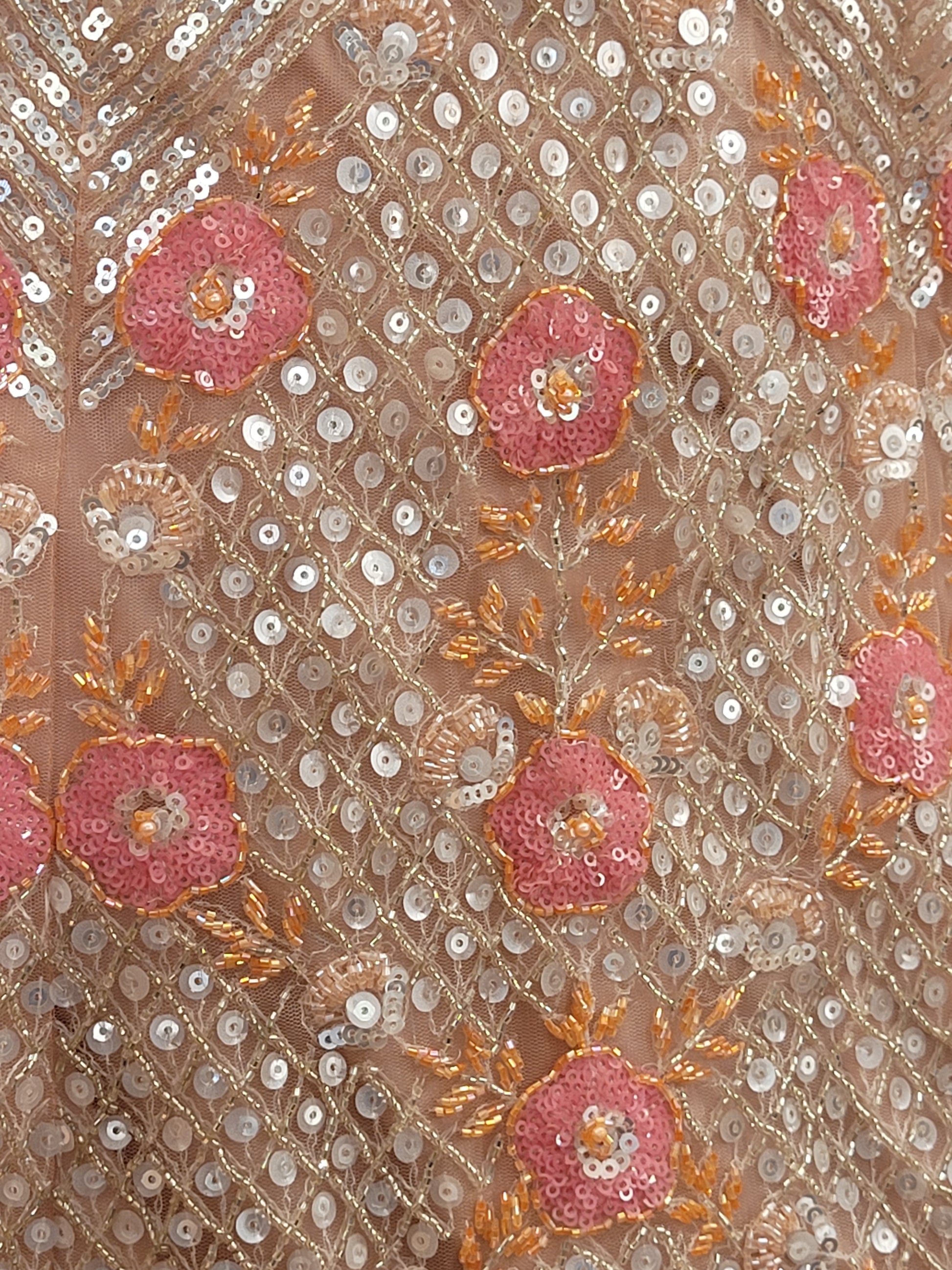 Elevate your ethnic wardrobe with this stunning ivory-colored net unstitched lehenga, a perfect blend of traditional craftsmanship and contemporary elegance. This lehenga is intricately adorned with shimmering water sequins and delicate glass beads work, creating a mesmerizing effect that catches the light with every movement.
