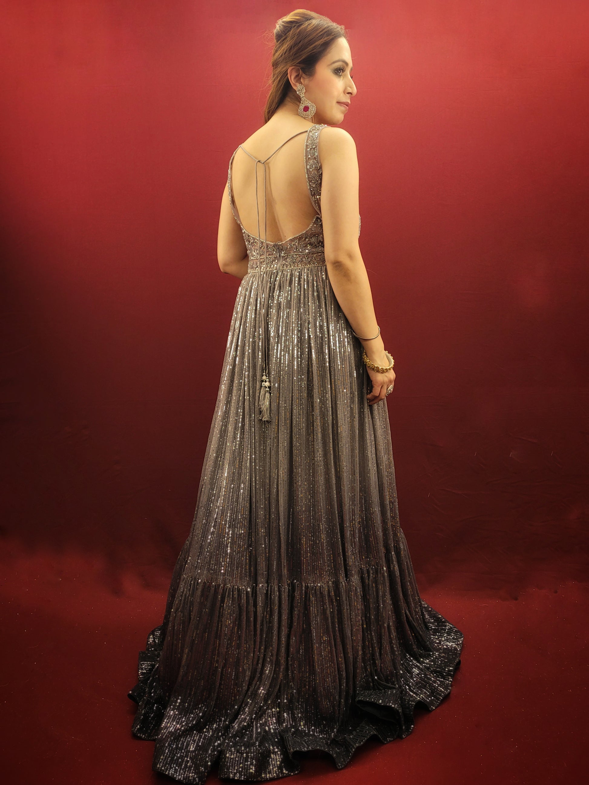 The perfect gown to wear to your upcoming engagement, cocktail party, or wedding reception. Allow us to introduce you to this stunning silver grey gown made from imported fabric and adorned with intricate cutdana beads and sequins work.