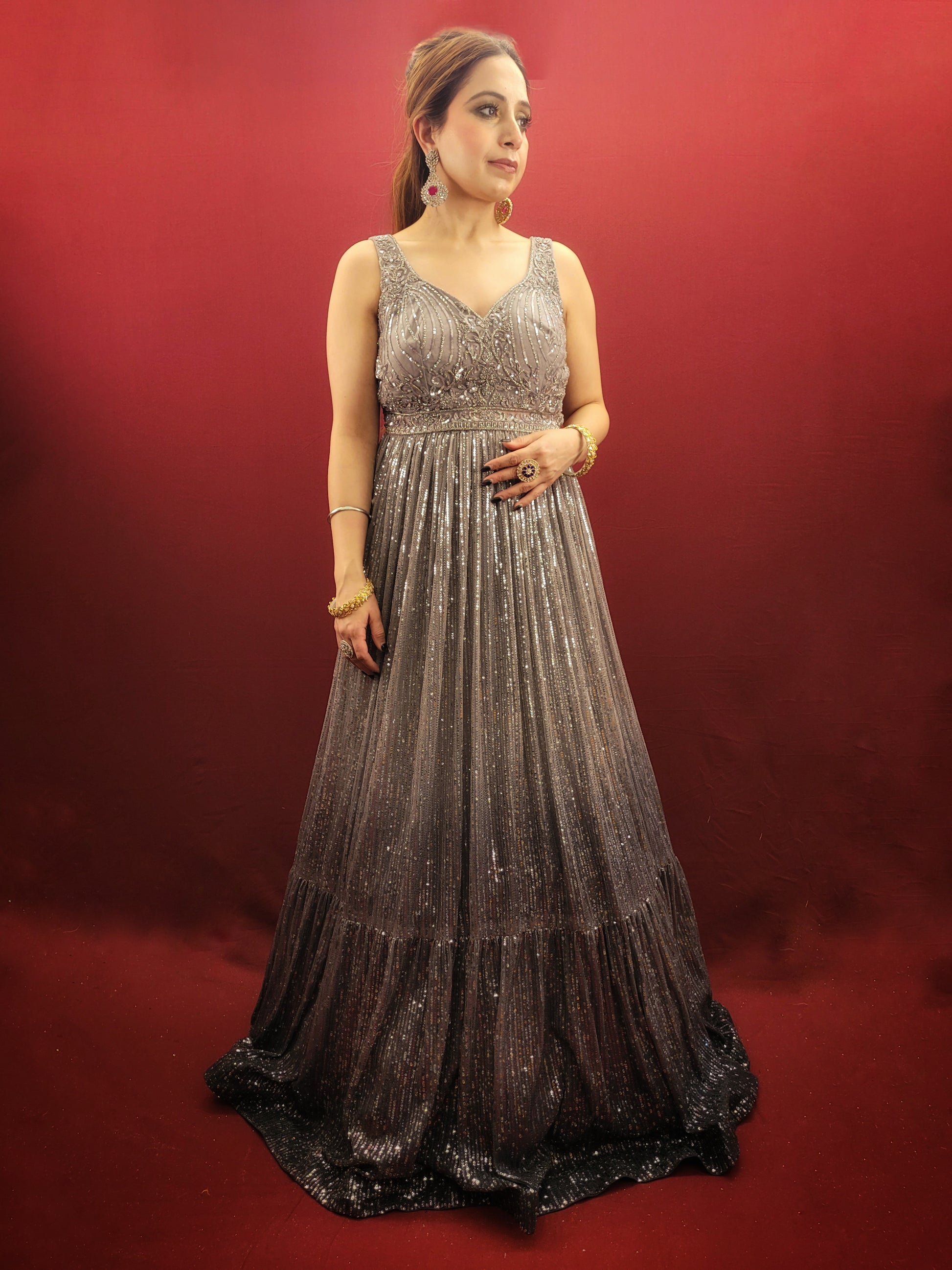 The perfect gown to wear to your upcoming engagement, cocktail party, or wedding reception. Allow us to introduce you to this stunning silver grey gown made from imported fabric and adorned with intricate cutdana beads and sequins work.