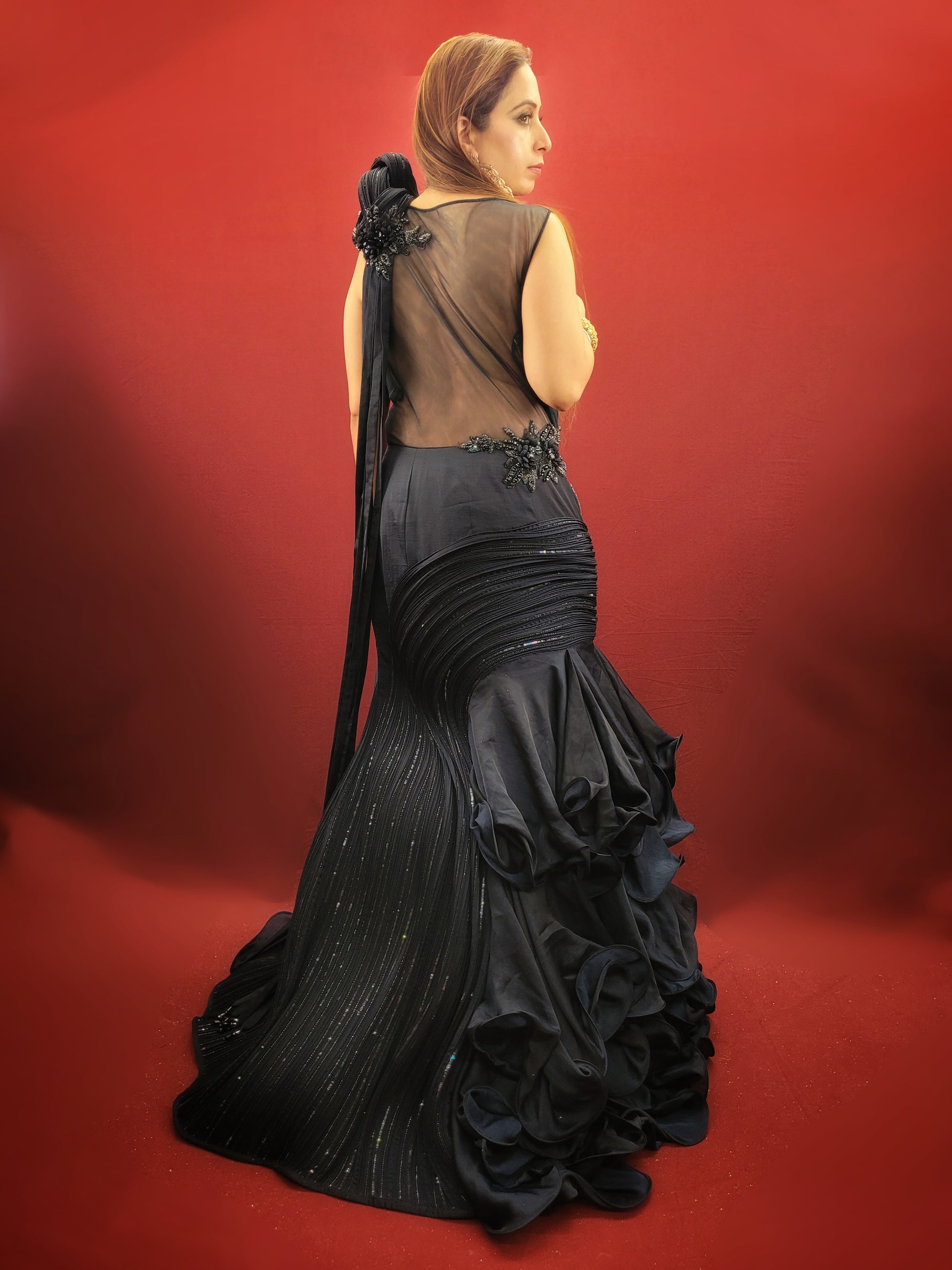 Looking for a stunning gown that will make you stand out at your engagement, cocktail, or reception? Look no further than this navy blue imported fabric gown, featuring design inspiration from ace designer Gaurav Gupta.