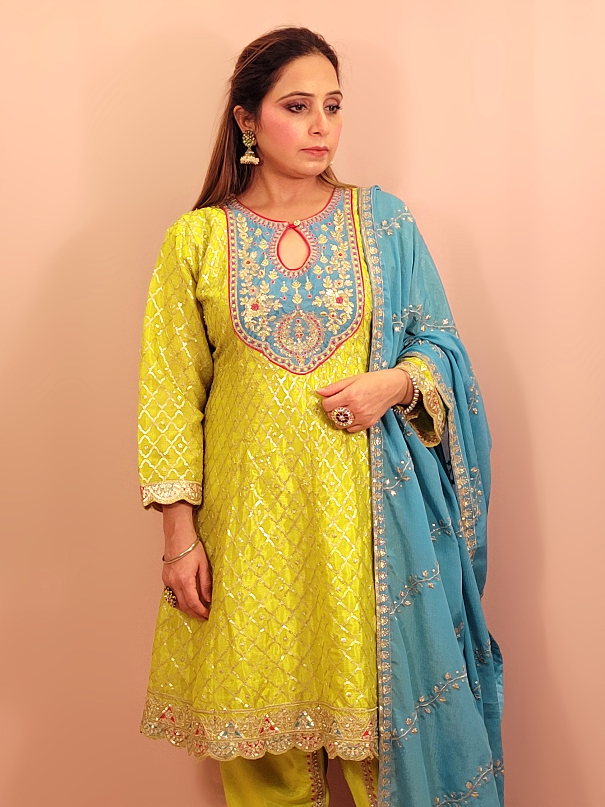 Green Chinnon Anarkali with matching Tulip Pants. Contrast neck yolk with resham, zari and sequins. Contrast Dupatta. Latest trend in Indian ethnic fusion wear.