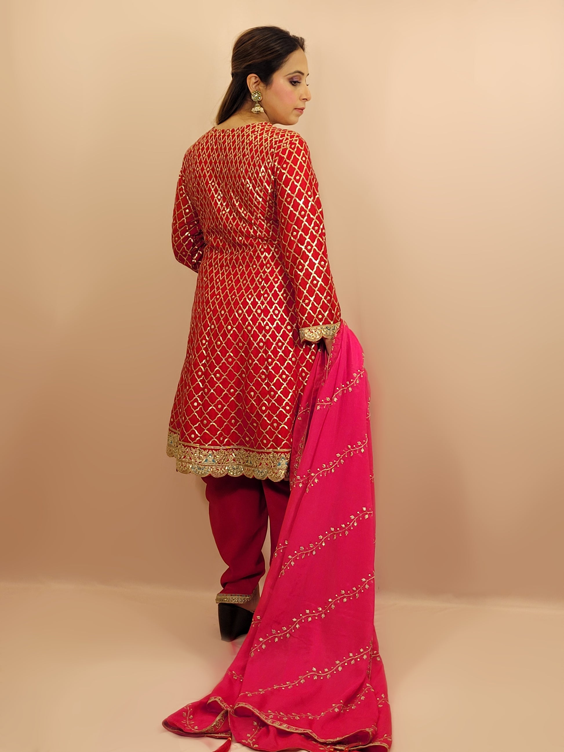 Red Chinnon Anarkali with matching Tulip Pants. Contrast neck yolk with resham, zari and sequins. Contrast Dupatta. Latest trend in Indian ethnic fusion wear.