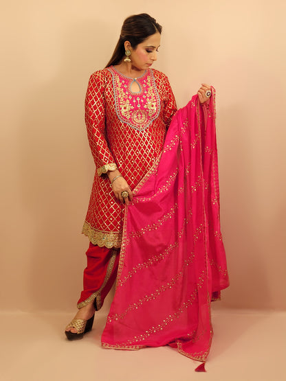 Red Chinnon Anarkali with matching Tulip Pants. Contrast neck yolk with resham, zari and sequins. Contrast Dupatta. Latest trend in Indian ethnic fusion wear.