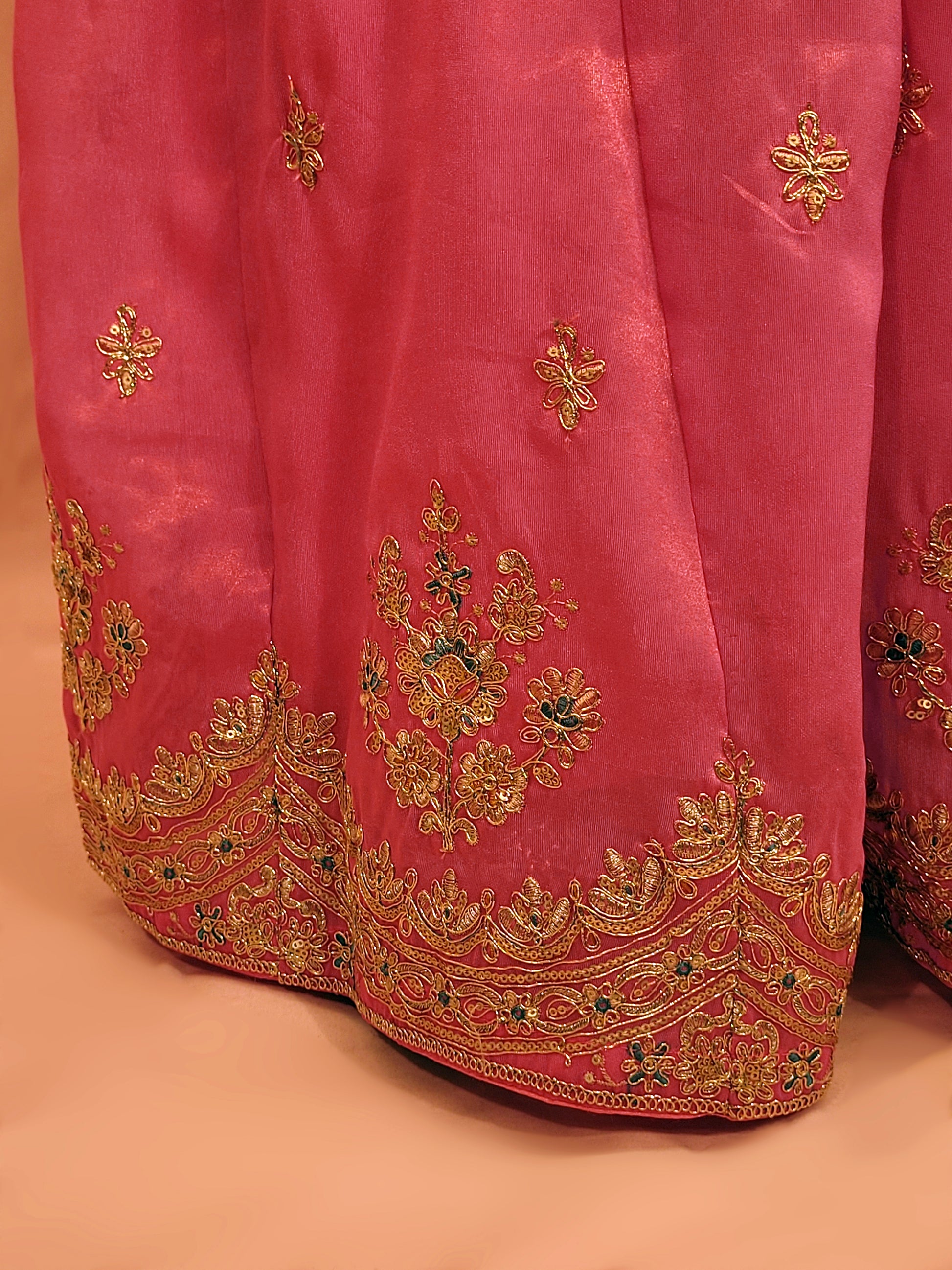 Pink Shimmer Sharara Suit. Heavy Zari Sequins Neckline. Heavy sleeves, bottom and dupatta.
