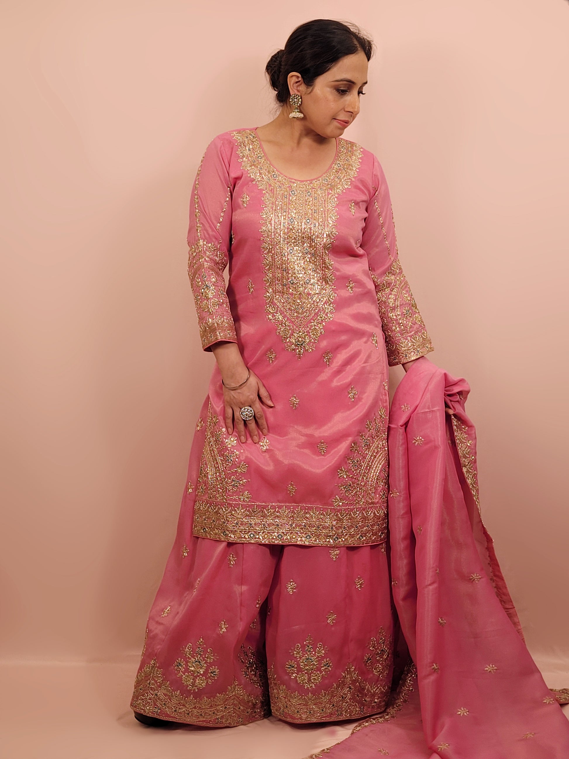 Pink Shimmer Sharara Suit. Heavy Zari Sequins Neckline. Heavy sleeves, bottom and dupatta.