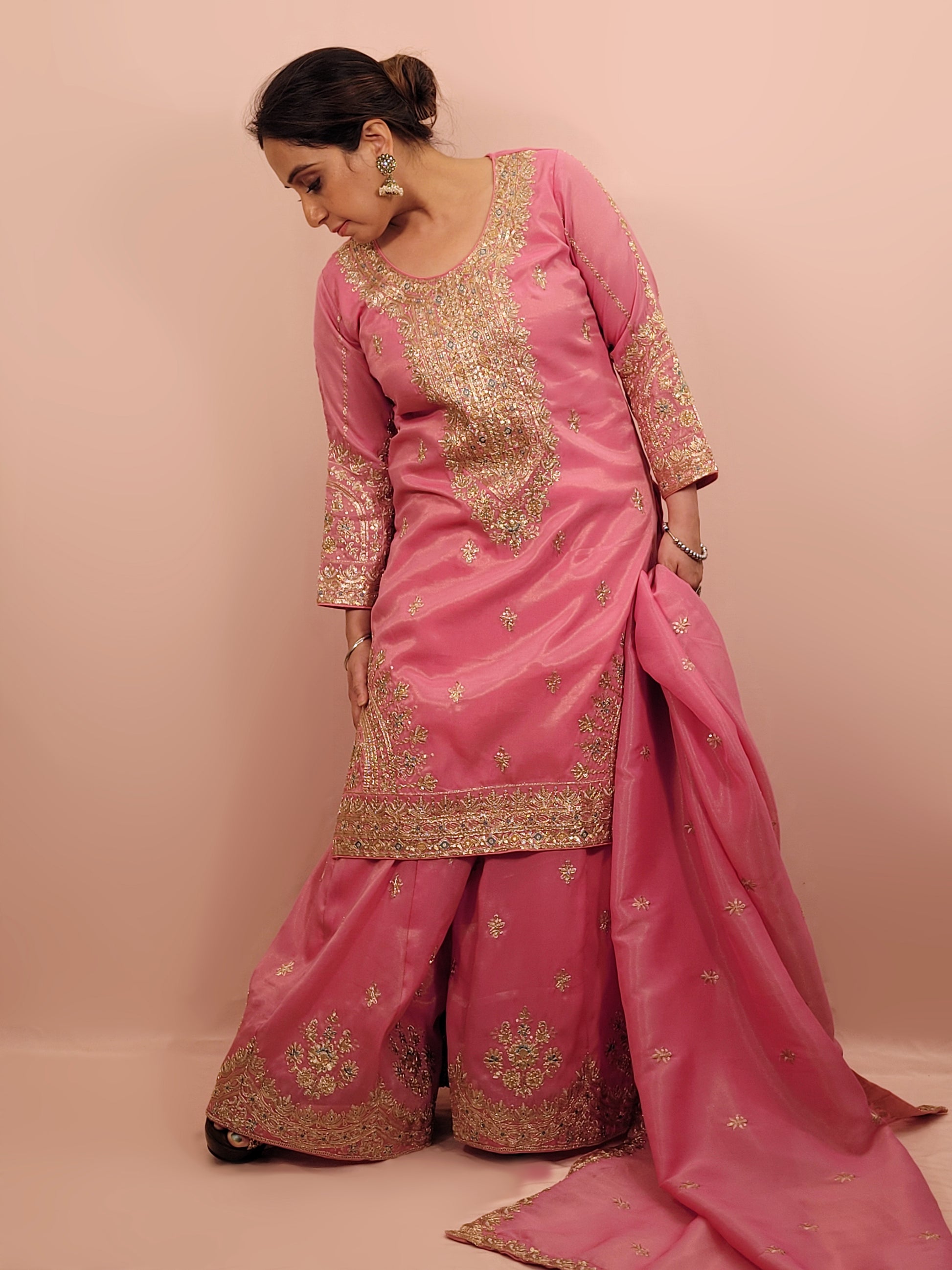 Pink Shimmer Sharara Suit. Heavy Zari Sequins Neckline. Heavy sleeves, bottom and dupatta.
